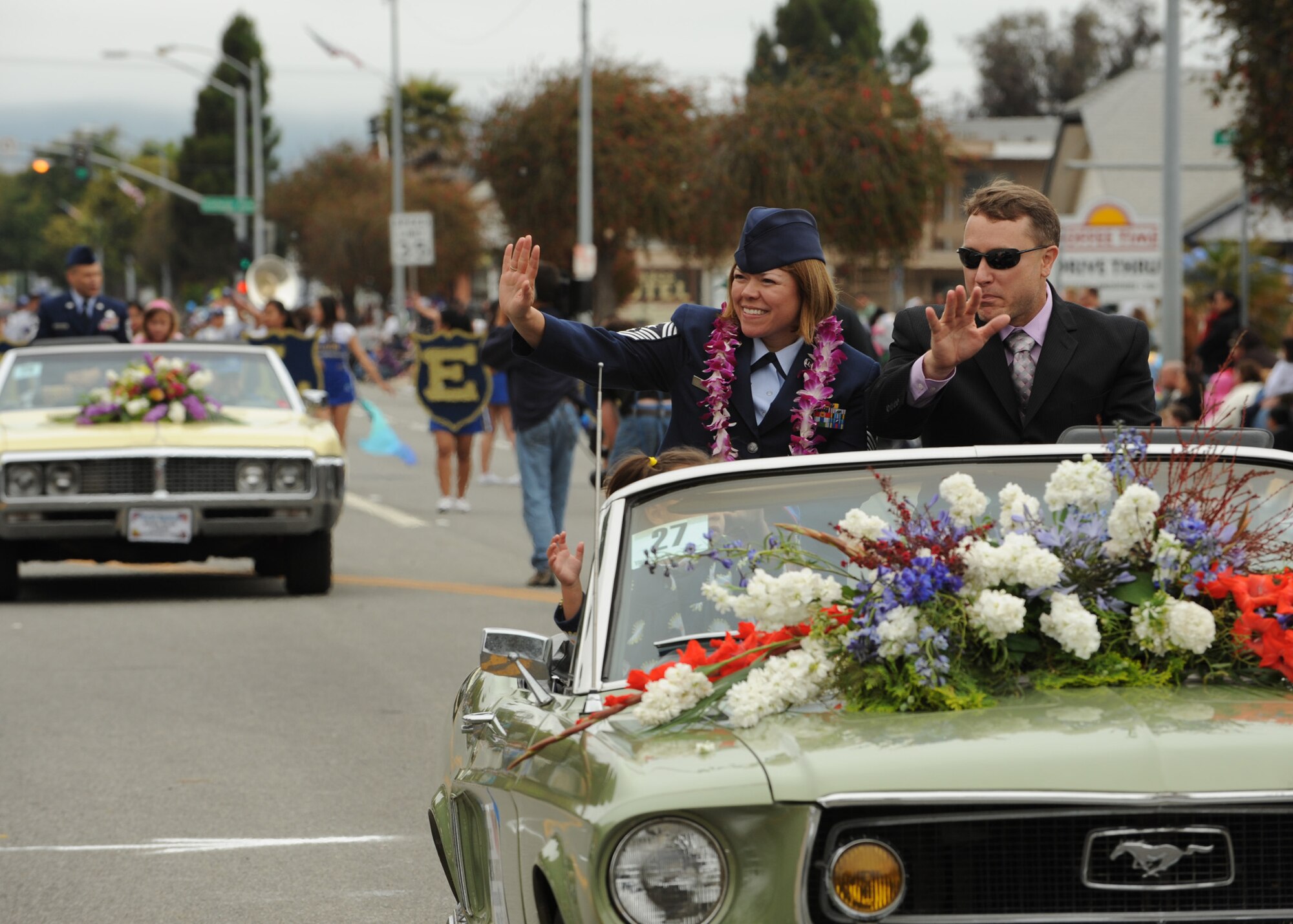 LOMPOC, Calif. --  Chief Master Sgt. Angelica Johnson, the 30th Space Wing command chief, rides along with her husband in the Flower Festival parade here Saturday, June 26, 2010. The Flower Festival is annual event that is planned for the third week of June so that major crops of flowers will be in bloom. (U.S. Air Force Photo/Senior Airman Bryan Boyette)