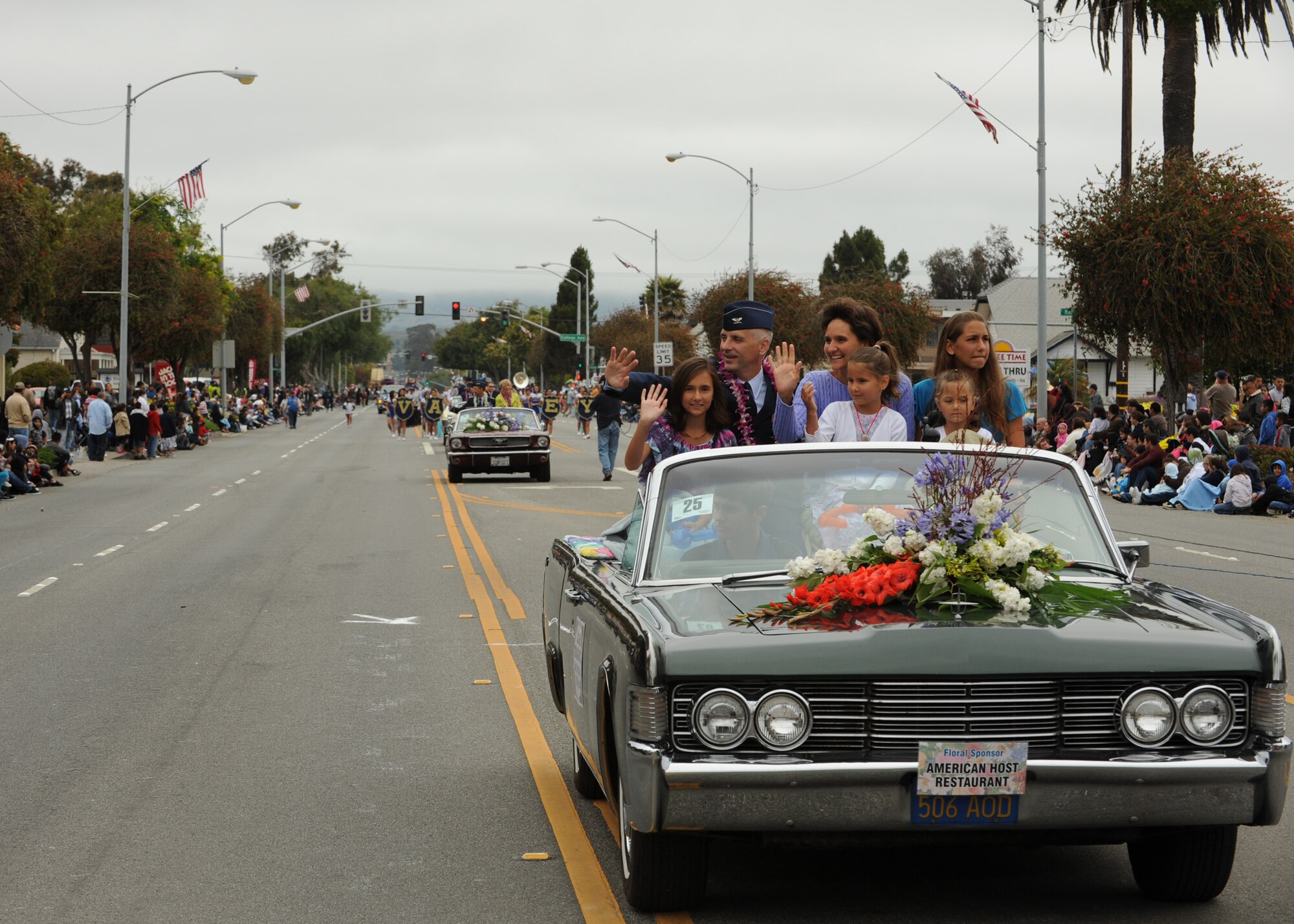 LOMPOC, Calif. --  Col. Richard Boltz, the 30th Space Wing commander, and his family, represent the Vandenberg Air Force Base community during a ride along in the Flower Festival parade here Saturday, June 26, 2010. The Flower Festival is annual event that is planned for the third week of June so that major crops of flowers will be in bloom. (U.S. Air Force Photo/Senior Airman Bryan Boyette)