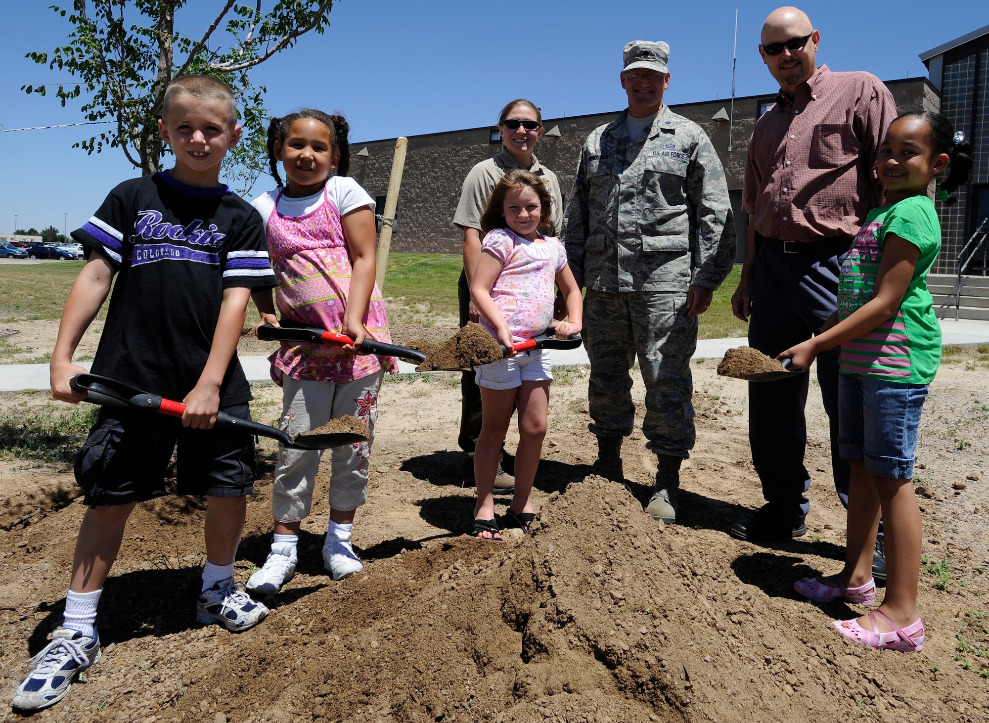 BUCKLEY AIR FORCE BASE, Colo. -- Collin Hagans, Sasha Laity, Quinn Duncan and Jasmin Cole, base dependents, pose with Krystal Phillips, 460th Civil Engineer Squadron fish and wildlife biologist, Lt. Col. William Morrison, 460th Mission Support Group deputy commander and Keith Wood, a Colorado State Forester, after planting a tree at the Arbor Day celebration June 30. (U.S. Air Force photo by Staff Sgt. Dallas Edwards)