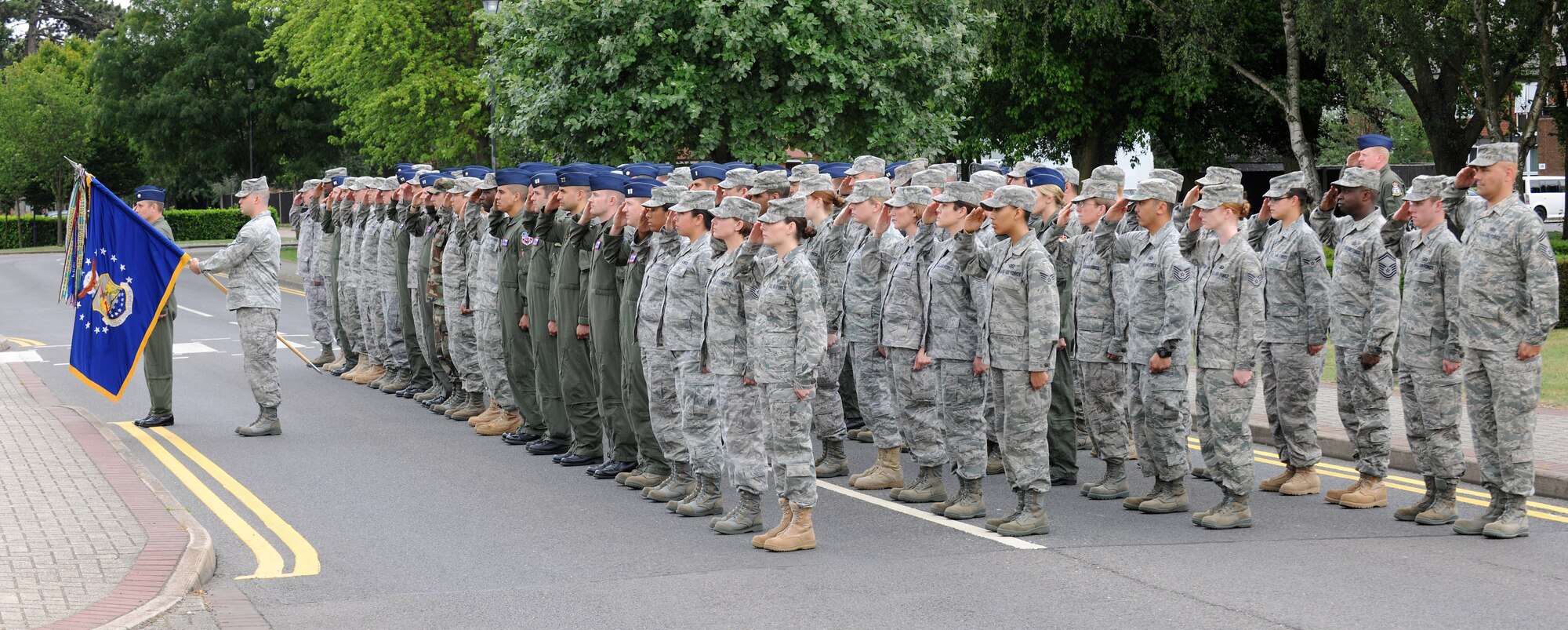 RAF MILDENHALL, England – Members from 100th Air Refueling Wing staff agencies salute during a retreat ceremony at the wing headquarters March 24.  Retreat signals the end of the duty day while also paying respect to the flag. (U.S. Air Force photo/ Staff Sgt. Jerry Fleshman)