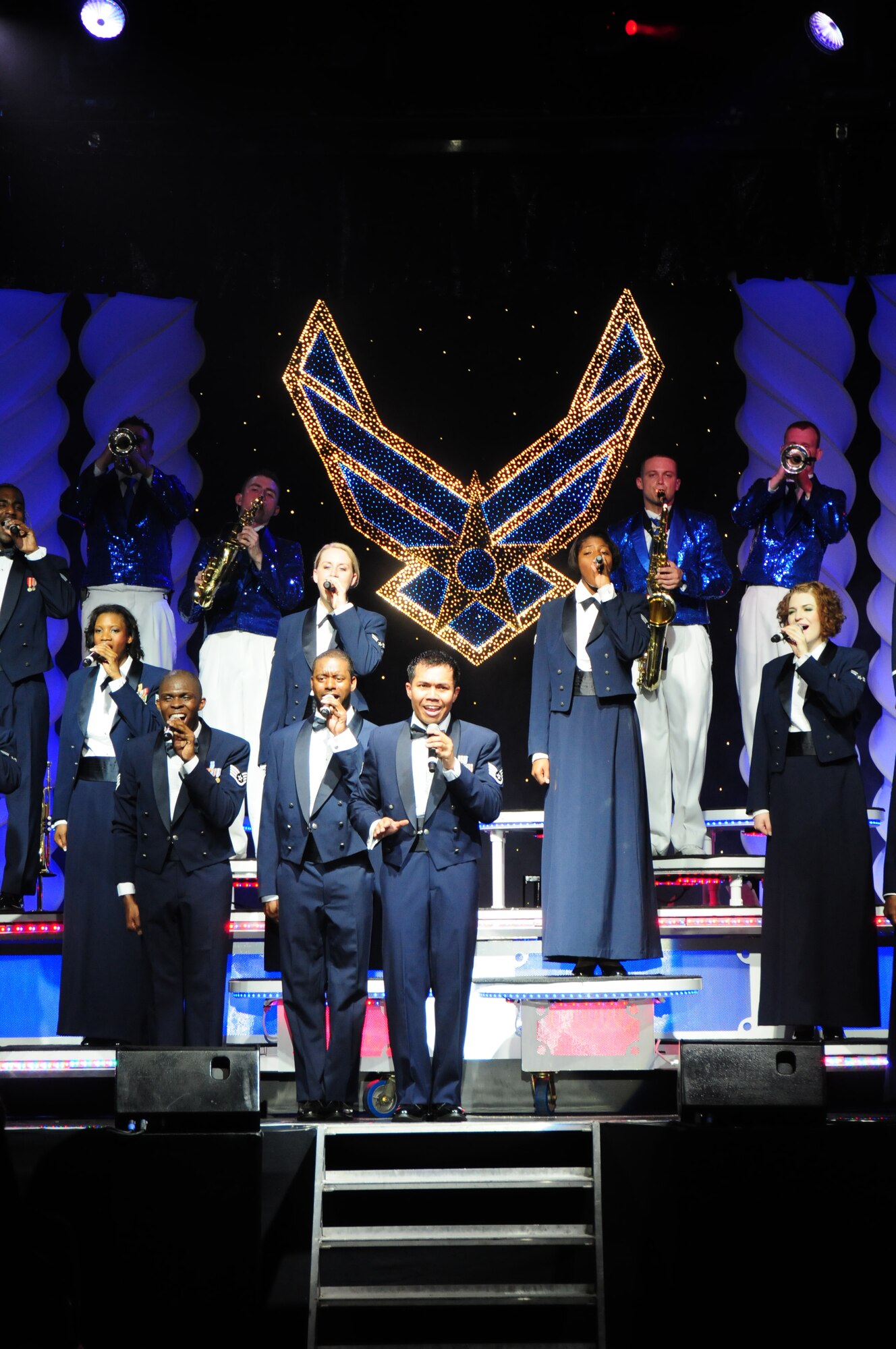 Tops In Blue performers sing "Proud to be an American" for the final performance of the night at RAF Lakenheath, England, June 30. “Proud to be an American” has been the final song for every Tops In Blue performance for the last 25 years. Tops In Blue tours every year visiting stateside bases and overseas locations providing expeditionary entertainment for Airmen, families and members of the local community. (U.S. Air Force photo/Airman 1st Class Lausanne Morgan)