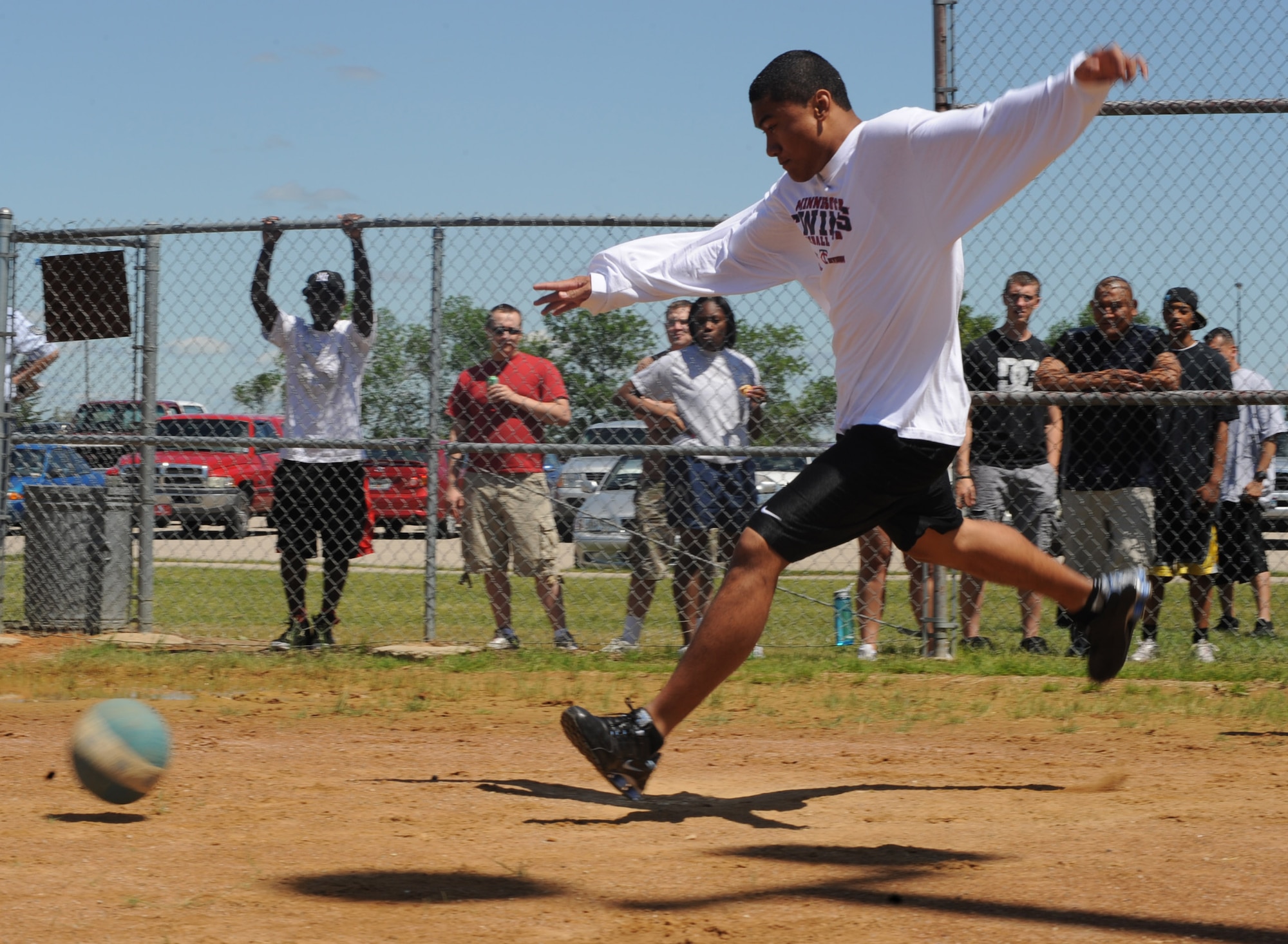 Senior Airman Amosa Farani, 319th Force Support Squadron, prepares to blast a kickball during the "Full-metal" Kickball tournament at Grand Forks Air Force Base, N.D. June 28, 2010. The Network 5/6 team, comprised of staff sergeants and technical sergeants took the championship in the final game. (U.S. Air Force photo by Airman First Class Amber Price)
