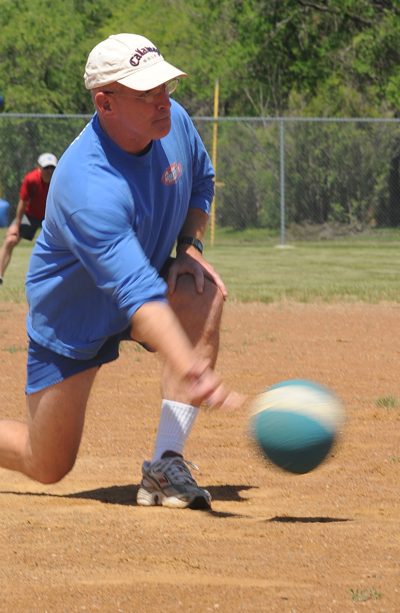 Col. John Quinn, 319th Air Refueling Wing vice-commander rolls a pitch to his team's opponent during the "Full-metal" Kickball tournament at Grand Forks Air Force Base, N.D. June 28, 2010. The Network 5/6 team, comprised of staff sergeants and technical sergeants took the championship in the final game. (U.S. Air Force photo by Airman First Class Amber Price)