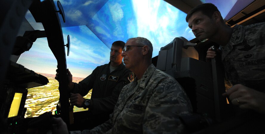 MOODY AIR FORCE BASE, Ga. -- Capt. Dylan Thorpe, 23rd Operation Support Squadron current operations flight commander, gives an overview of the controls to Maj. Gen. William Holland, 9th Air Force commander, as Col. Gary Henderson, 23rd Wing commander, looks on here June 29. In General Holland’s early career, he was an A-10 Thunderbolt II pilot and received the opportunity to fly in the A-10 simulator during his base visit. (U.S. Air Force photo by Airman 1st Class Benjamin Wiseman/RELEASED)