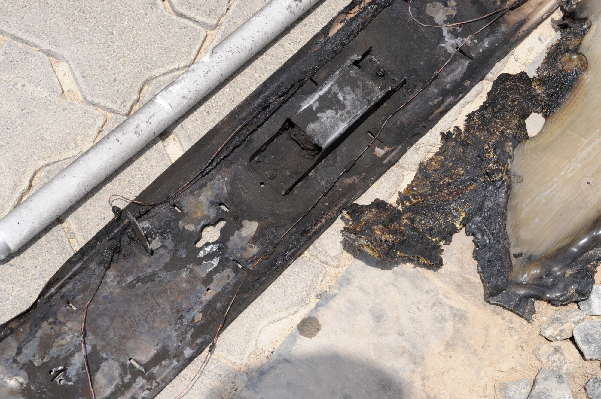 A damaged light fixture is shown after a fire June 30 at a non-disclosed base in Southwest Asia. The 380th Expeditionary Civil Engineer fire fighter’s quick response minimized damage to the building. (U.S. Air Force photo/Tech. Sgt. April Wickes) 