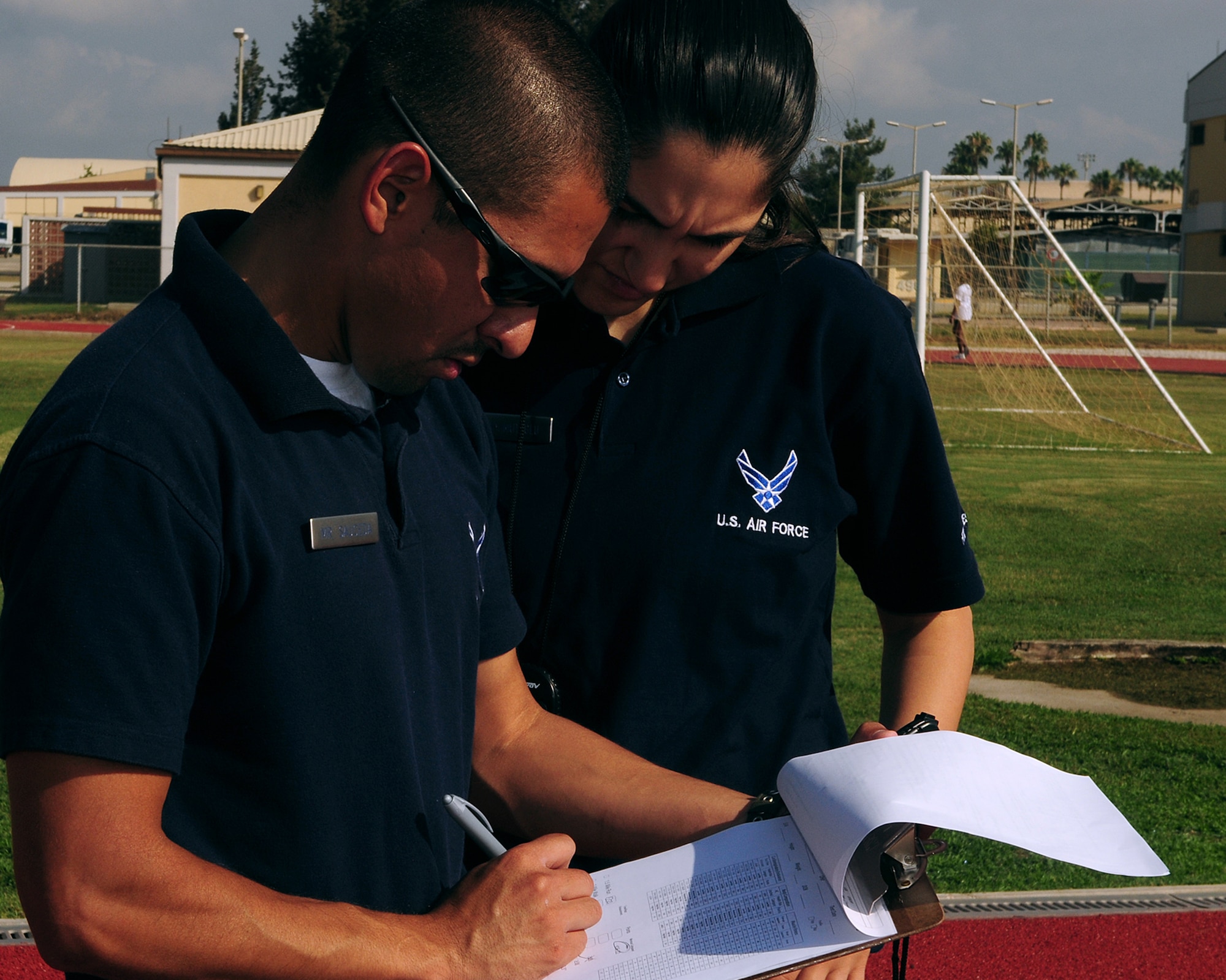Jaime Sauceda (left) and Derya Mahmutoglu, fitness assessment cell test facilitators, tally up points of a mock physical assessment test Tuesday, June 29, 2010 at Incirlik Air Base, Turkey. For the past two months, the FAC has offered practice PT tests, and officially began administering all base physical fitness tests July 1. This new PT program is in accordance with a new Air Force-wide PT policy. (U.S. Air Force photo/Senior Airman Alex Martinez)