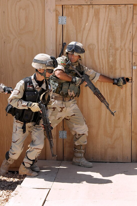 Getting ready to enter a building, Iraqi Army soldiers practice room clearing techniques for a future air assault operation, Camp Kassum, Al Asad Air Base, Iraq, June 22, 2010.
