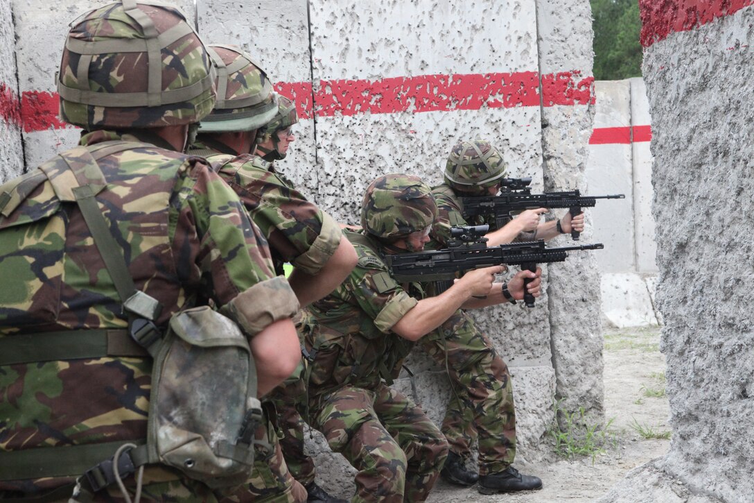 British service members with 30 Commando IX (Information Exploitation) Group, 3 Commando Brigade, Royal Marines, practice room-clearing techniques while moving through a building a live-fire training exercise at the Military Operations on Urban Terrain facility aboard Marine Corps Base Camp Lejeune, July 1.  This exercise helped the British Commandos to hone their close-combat skills and have practical, hands-on experience with room clearance techniques.
