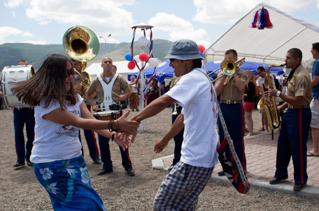 A couple dances to the sounds of the U.S. Marine Corps Forces Pacific Party Band at an Independence Day celebration at the International School of Ulaanbaatar, Mongolia, July 3. The MarForPac Band was in Mongolia sharing their time and talents with the Mongolian Armed Forces Band and held several free, public concerts.