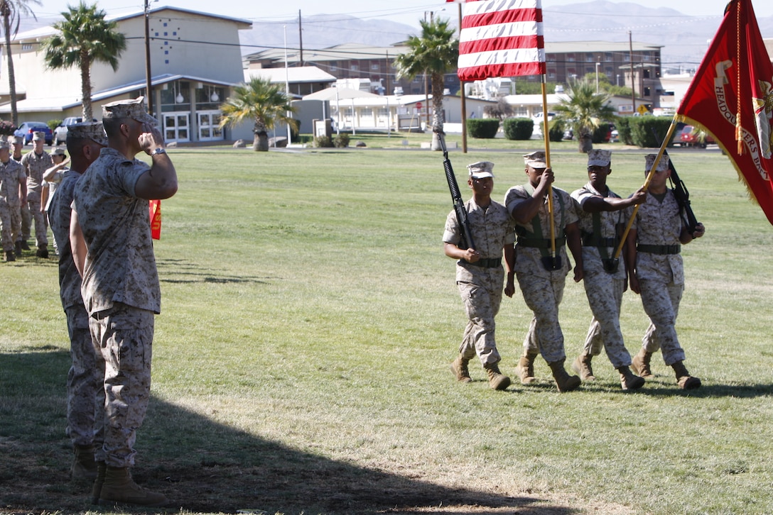 Lieutenant Col. Brandon D. McGowan [left] and Lt. Col. Phillip Zeman render honors to the colors during a change of command ceremony at the Combat Center's Lance Cpl. Torrey L. Gray Field July 2. Zeman replaced McGowan as the commander of the Combat Center's Headquarters Battalion.