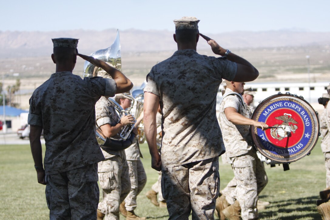 Lieutenant Col. Brandon D. McGowan [left] and Lt. Col. Phillip Zeman salute the band during a change of command ceremony at the Combat Center’s Lance Cpl. Torrey L. Gray Field July 2. Zeman replaced McGowan as the commander of the Combat Center’s Headquarters Battalion here.