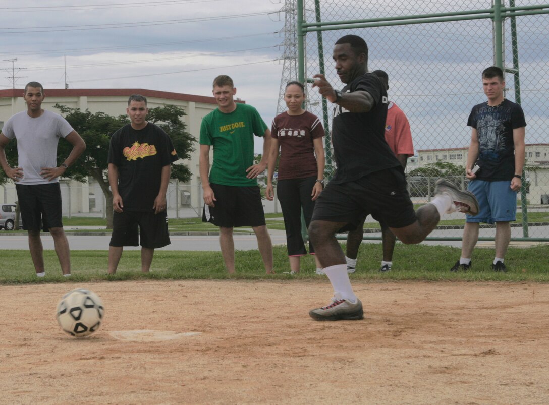 Lance Cpl. Ronald Campbell, warehouse clerk with Combat Logistics Regiment 3,  3rd Marine Logistics Group, III Marine Expeditionary Force, prepares to kick the ball during a game of kickball at CLR 3’s fun day, July 2.