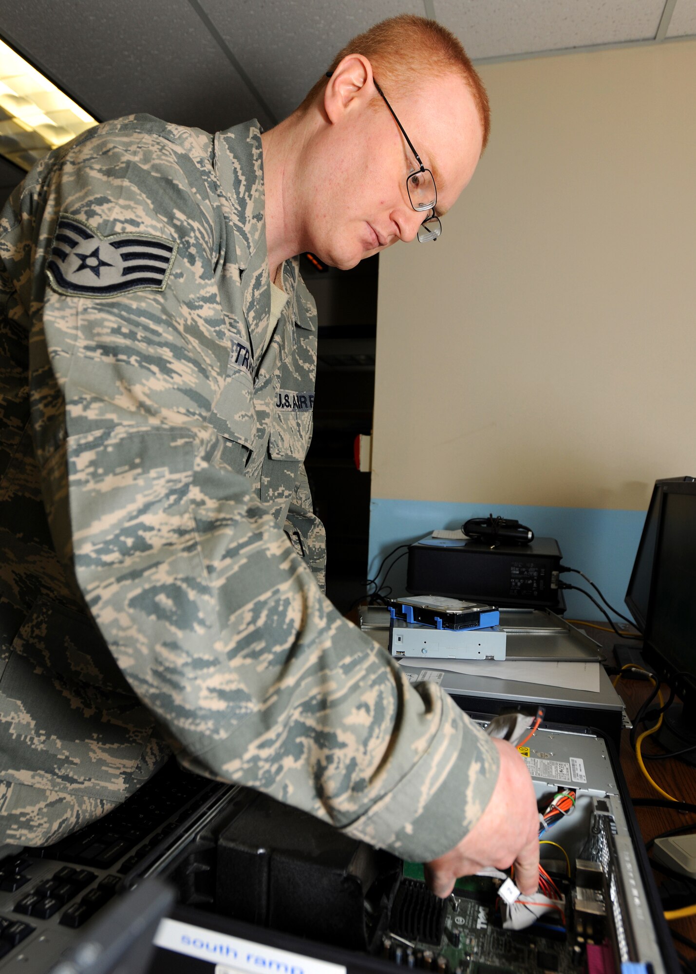 Staff Sgt. Christopher Tracy troubleshoots hardware breakdown issues on a computer June 2, 2010, Eielson Air Force Base, Alaska.  The Network Control Center is responsible for over 2,200 computers on the base and take over 1,000 calls monthly.  Staff Sgt. Tracy is a Client Support Administrator with the 354th Communications Squadron.  (U.S. Air Force/Staff Sgt.Tia Wilson)