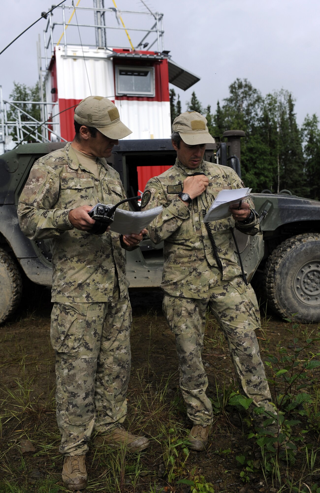An Italian Air Force Joint Terminal Air Controller calls in simulated airstrikes on a mock target during Distant Frontier July 2, 2010, Eielson Air Force Base, Alaska. The exercise is a joint combat training exercise that is essential to the success of air and ground operations. The JTAC is in constant communication with pilots identifying, marking, and later confirming successful hits. (U.S. Air Force photo/Airman 1st Class Willard E. Grande II)