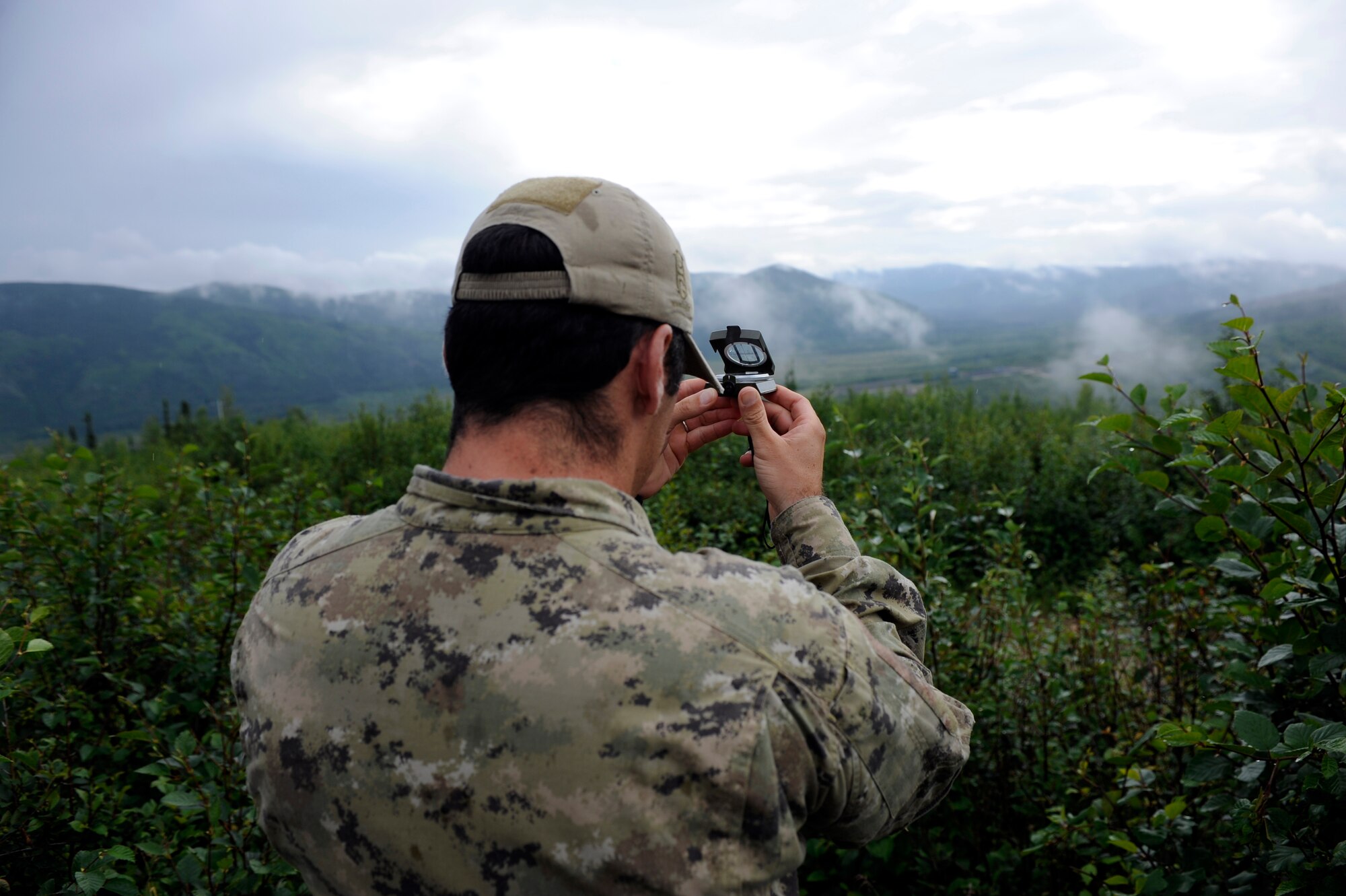 An Italian Air Force Joint Terminal Air Controller finds his heading using a compass during Distant Frontier July 2, 2010, Eielson Air Force Base, Alaska. The operation is a part of Distant Frontier, an exercise where aviation units sharpen their combat skills by flying sorties in a realistic threat environment. (U.S. Air Force photo/Airman 1st Class Willard E. Grande II)
