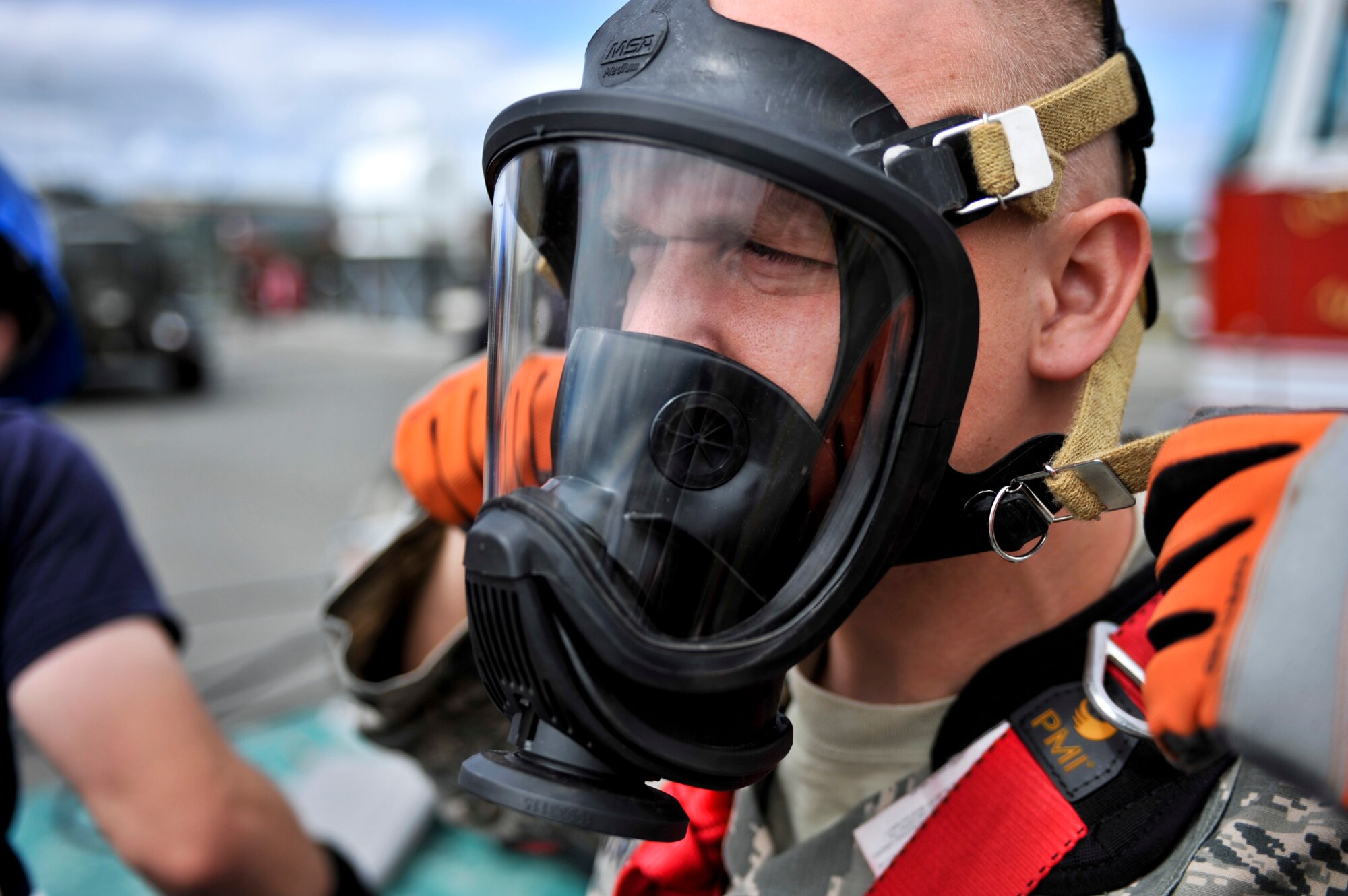 JOINT BASE ELMENDORF-RICHARDSON, Alaska – Senior Airman Justin Andreas, Joint Base Elmendorf-Richardson firefighter, tightens his oxygen mask in preparation for a confined space entry rescue drill June 30. JBER firefighters are required to be involved in this type of exercise annually. (Air Force photo by Airman 1st Class Christopher Gross)