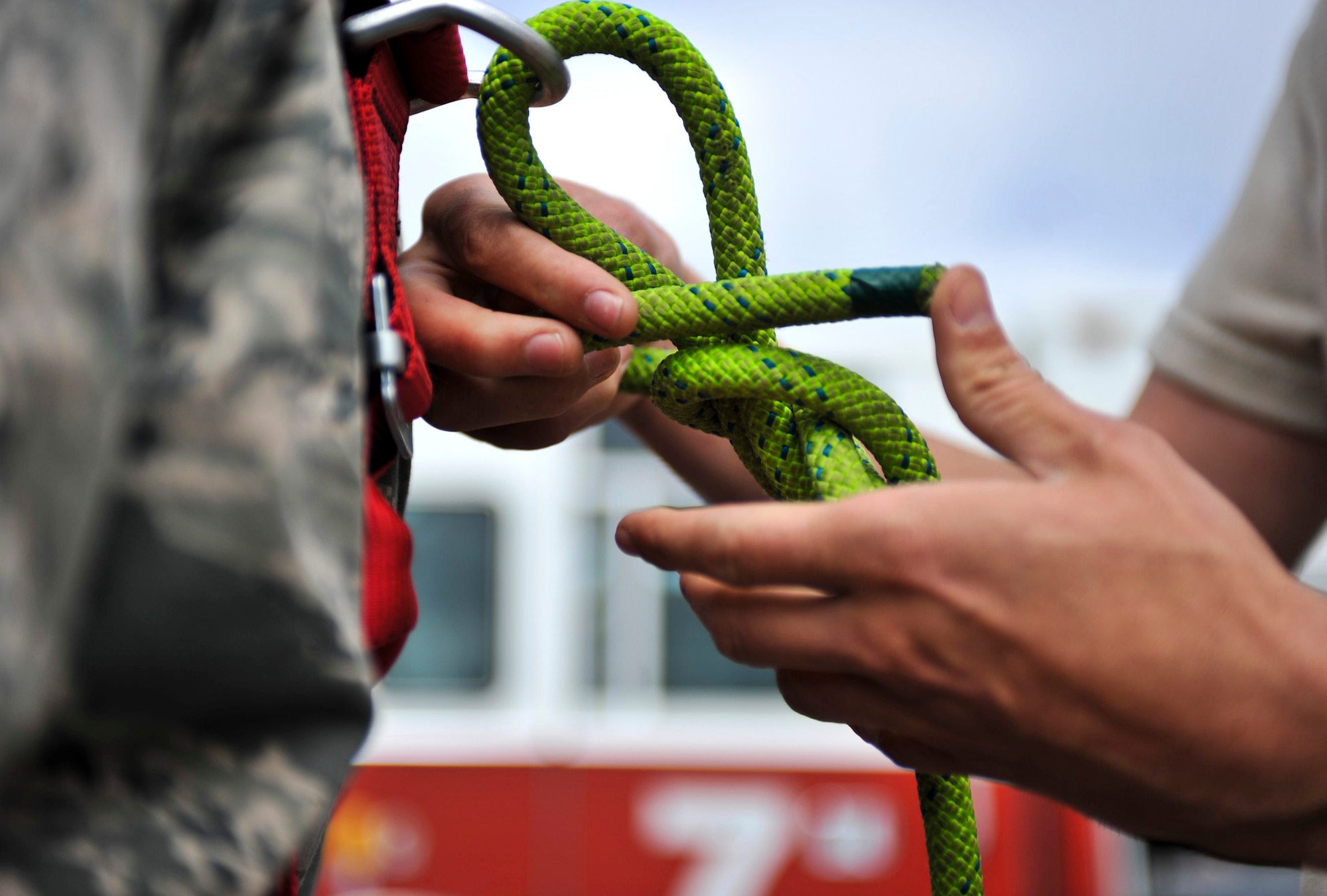 JOINT BASE ELMENDORF-RICHARDSON, Alaska – A member of the Joint Base Elmendorf-Richardson Fire Department rigs a knot for one of his fellow firefighters in preparation for a confined space entry rescue drill June 30. JBER firefighters are required to be involved in this type of exercise annually. (Air Force photo by Airman 1st Class Christopher Gross)