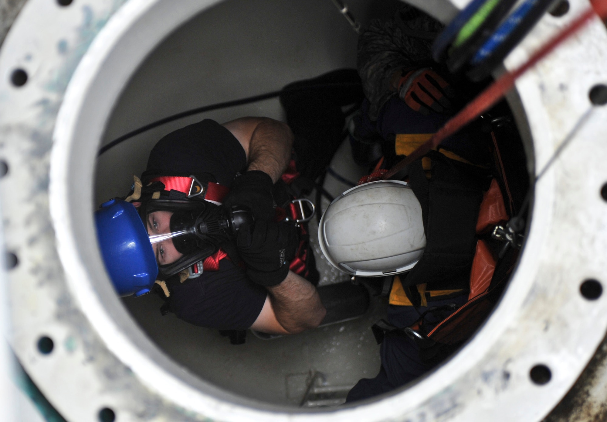 JOINT BASE ELMENDORF-RICHARDSON, Alaska – Mr. Blayne Ross, Joint Base Elmendorf-Richardson firefighter, gives the go ahead to pull up a simulated injured Airman during a confined space entry rescue drill June 30. JBER firefighters are required to be involved in this type of exercise annually. (Air Force photo by Airman 1st Class Christopher Gross)