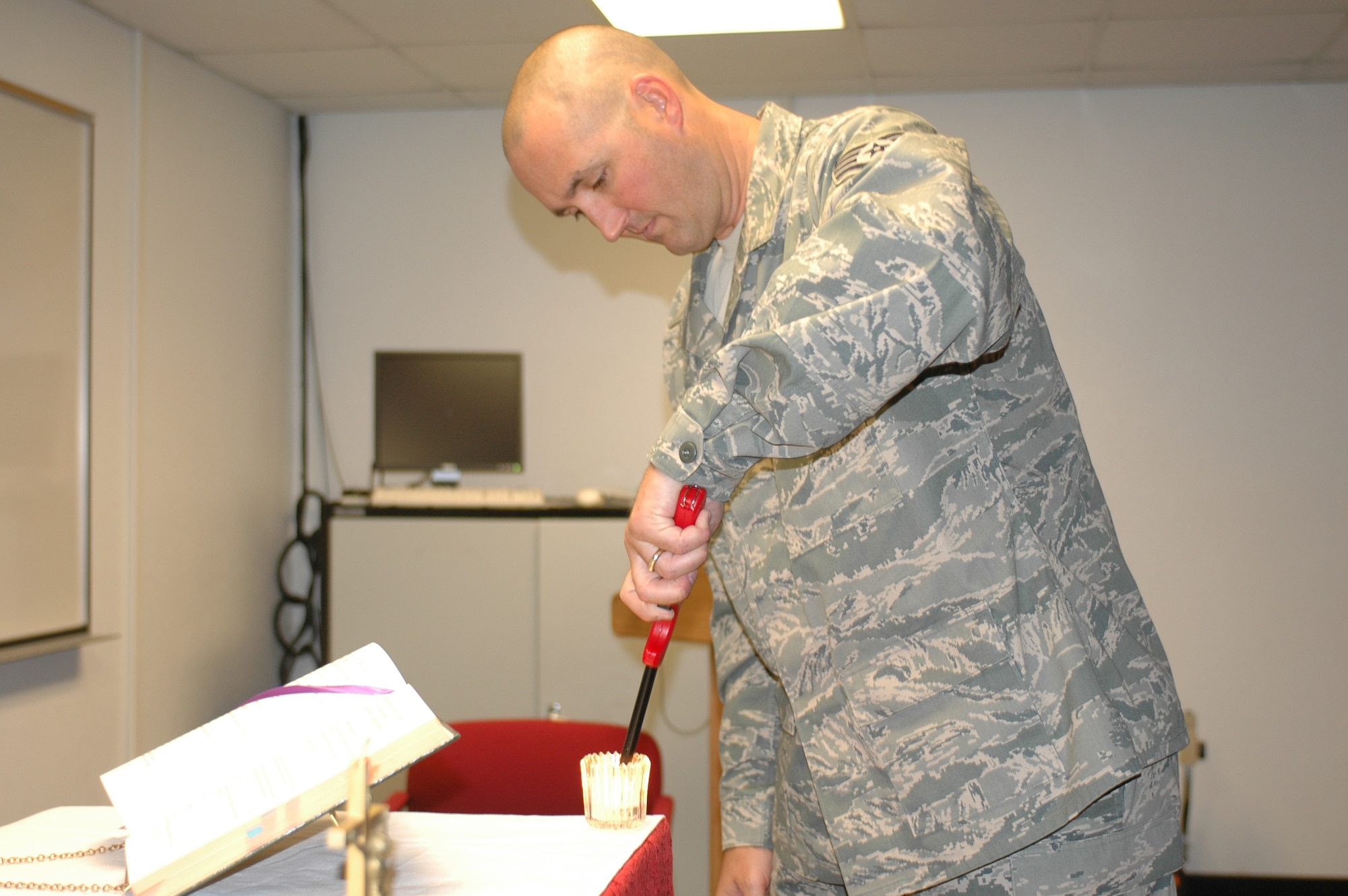 Stafff Sgt. Trevor Harvey, a chaplain's assistant at the Arizona Air National Guard's 162nd Fighter Wing, prepares for Catholic Mass on a drill weekend. (Air Force photo by Master Sgt. Desiree Twombly)