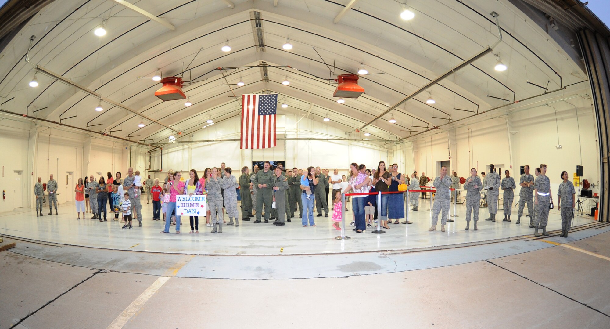 Friends and family members await the return of Cannon Airmen from overseas deployments, July 2, 2010. Operation Homecoming welcomed back Airmen from several squadrons with music and snacks. (U.S. Air Force photo by Airman 1st Class Maynelinne De La Cruz/Released)