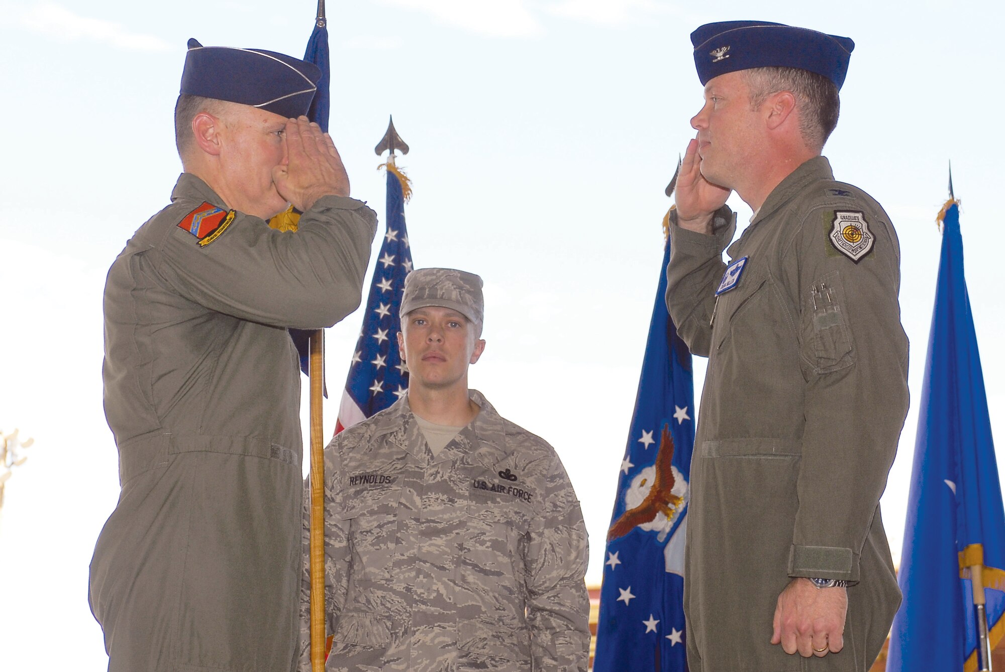 Brig. Gen. Kurt Neubauer, left, 56th Fighter Wing commander, returns a salute to Col. Douglas Miller, incoming 56th Operations Group commander, June 25th during a change of command ceremony held in Hangar 913 at Luke AFB, Arizona. (U.S. Air Force photo by Senior Airman Tracie Forte)