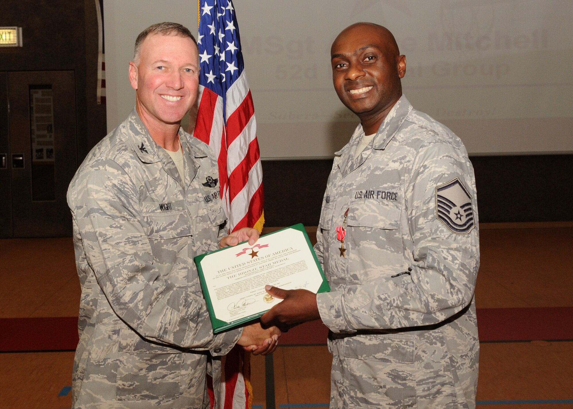 SPANGDAHLEM AIR BASE, Germany -- Col. Tip Wight, 52nd Fighter Wing commander, presents a citation to Master Sgt. Andre Mitchell, 52nd Medical Support Squadron medical logistics flight, after he was awarded a Bronze Star July 2.  The Bronze Star was presented to Sergeant Mitchell for meritorious service while assigned to the Combined Joint Special Operations Task Force in Afghanistan in 2008 and 2009.  (U.S. Air Force photo/ Airman 1st Class Nicholas Wilson)