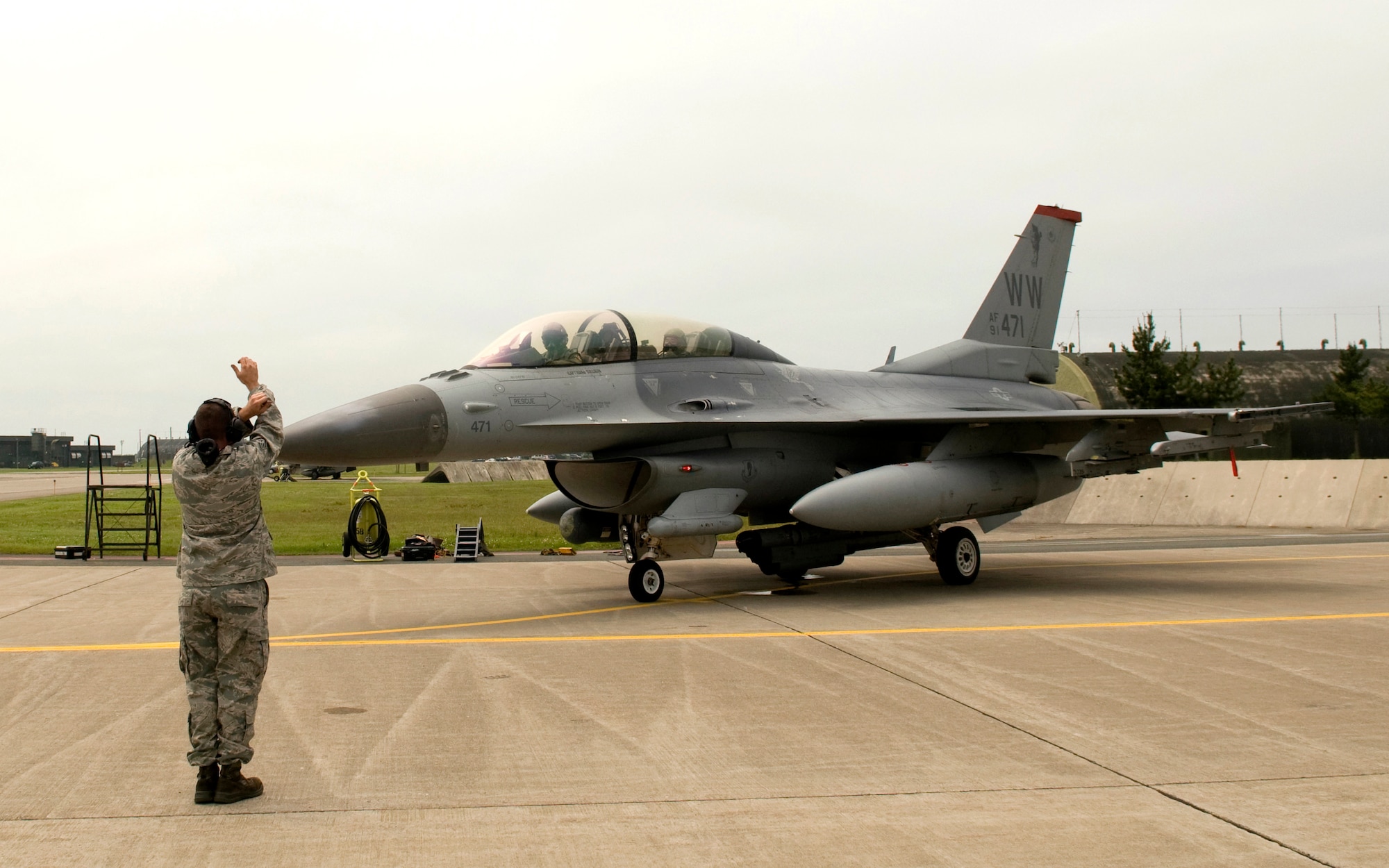 MISAWA AIR BASE, Japan ? As the honorary wing commander for the day, Misawa City Mayor Kazumasa Taneichi sits in the back seat of an F-16 Fighting Falcon while Col. David Stilwell, 35th Fighter Wing commander, prepares them to taxi, July 2. Mayor Taneichi received a mission briefing and toured several base facilities during the day-long event.   (U.S. Air Force photo/1st Lt. Jeff M. Nagan)