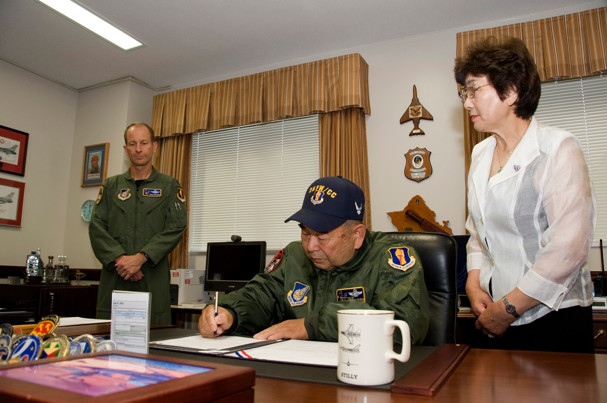 MISAWA AIR BASE, Japan -- Misawa City Mayor Kazumasa Taneichi, signs a document as his first official duty as the honorary wing commander, July 2. This program promotes goodwill and understanding between Misawa City and the base. (U.S. Air Force photo/ Staff Sgt. Araceli Alarcon) 