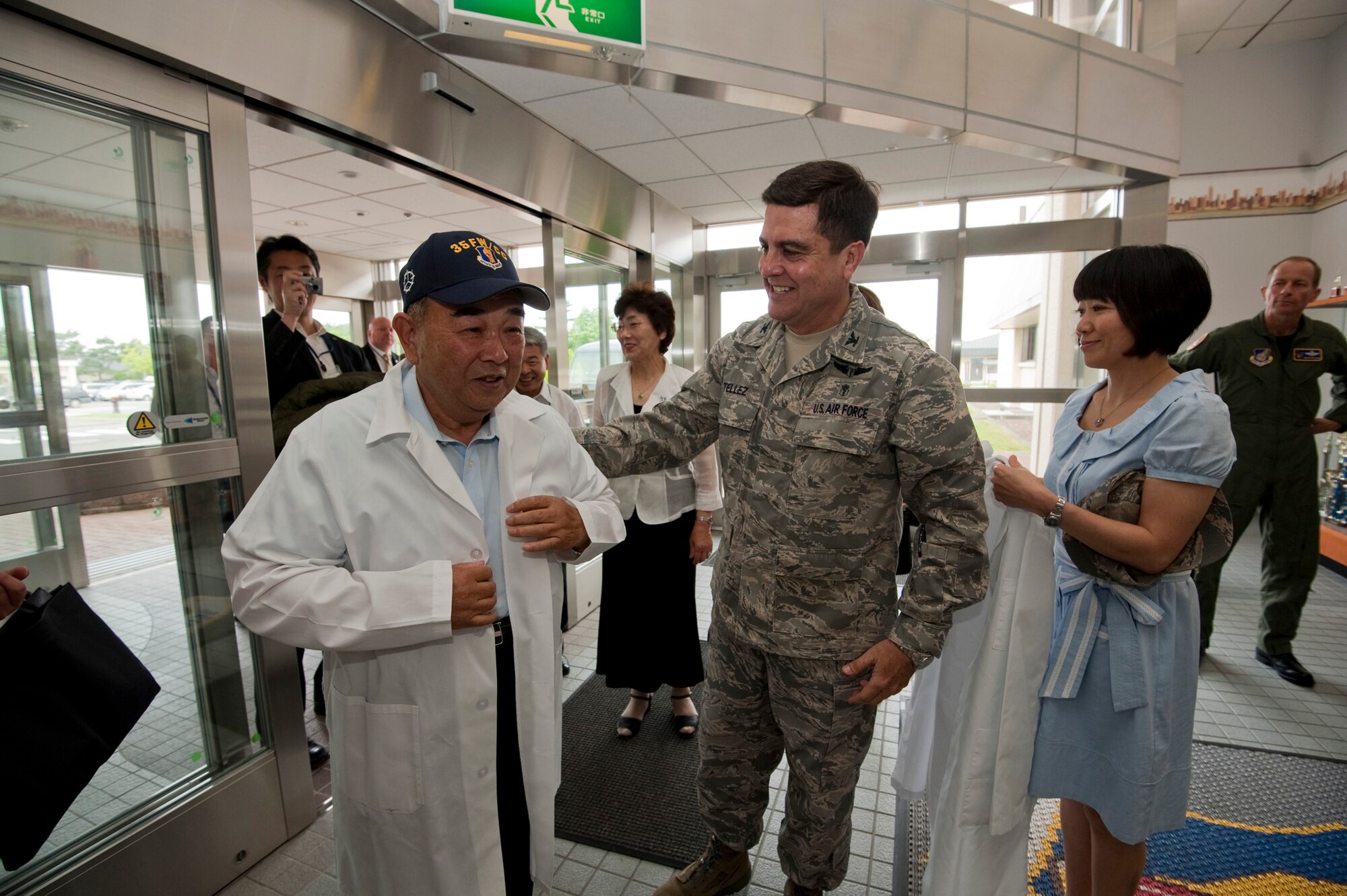 MISAWA AIR BASE, Japan -- Col. Guillermo Tellez, 35th Medical Group commander, presents a medical lab coat, July 2, to Kazumasa Taneichi, Misawa City mayor and honorary commander of the 35th Fighter Wing for the day. Mayor Taneichi assumed command of the 35th FW to gain an inside perspective of the role and mission of the Airmen of Misawa Air Base. (U.S. Air Force photo/Staff Sgt. Samuel Morse)