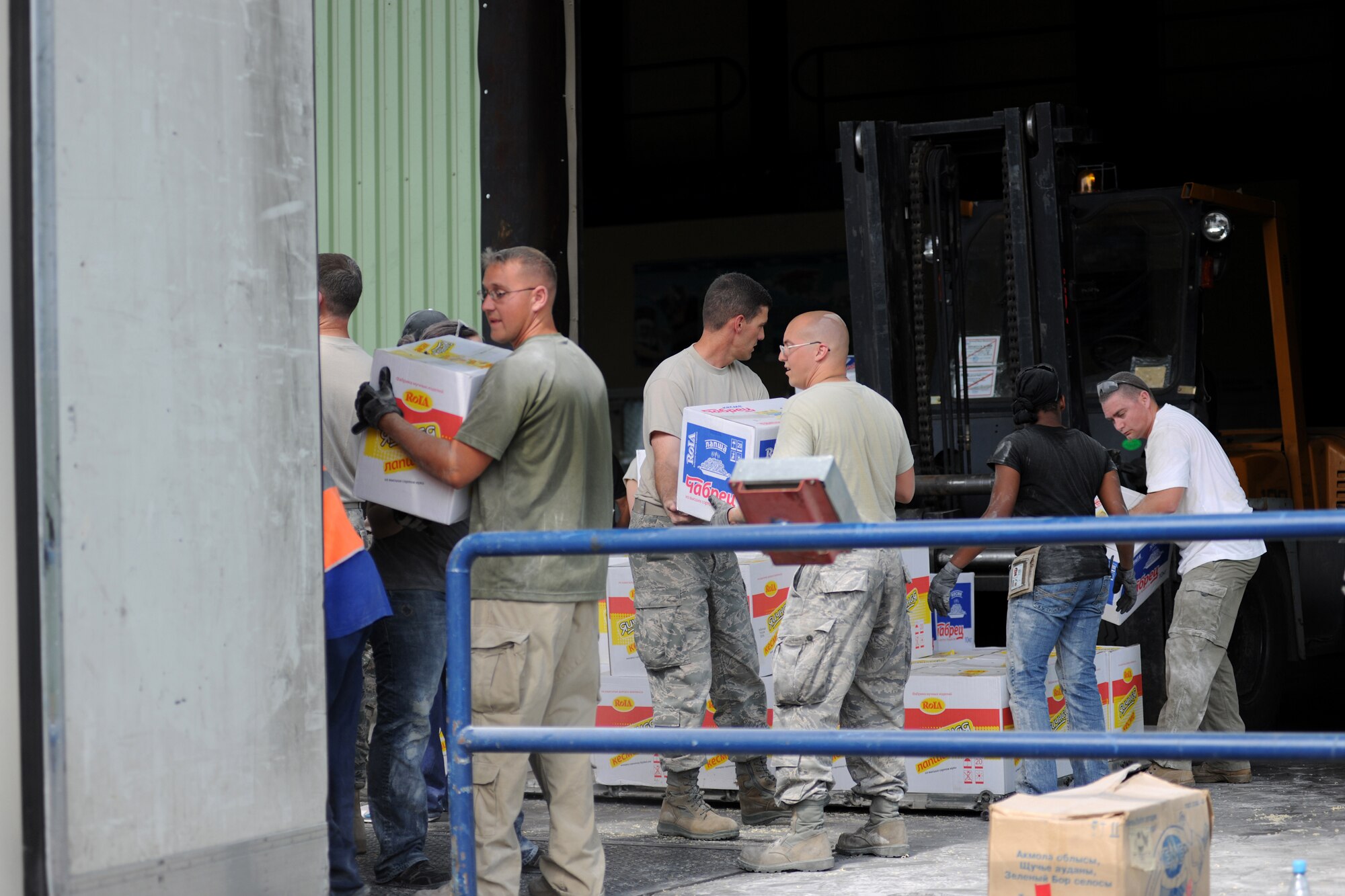 MANAS INTERNATIONAL AIRPORT, Kygryzstan - Twenty Airmen including the 376th Air Expeditionary Wing?s senior leadership volunteered to help Kyrgyz relief workers, at the Manas International Airport warehouse, load eight pallets into an 18-wheeler headed for Osh July 3. (U.S. Air Force photo/Staff Sgt. Michael Schocker)