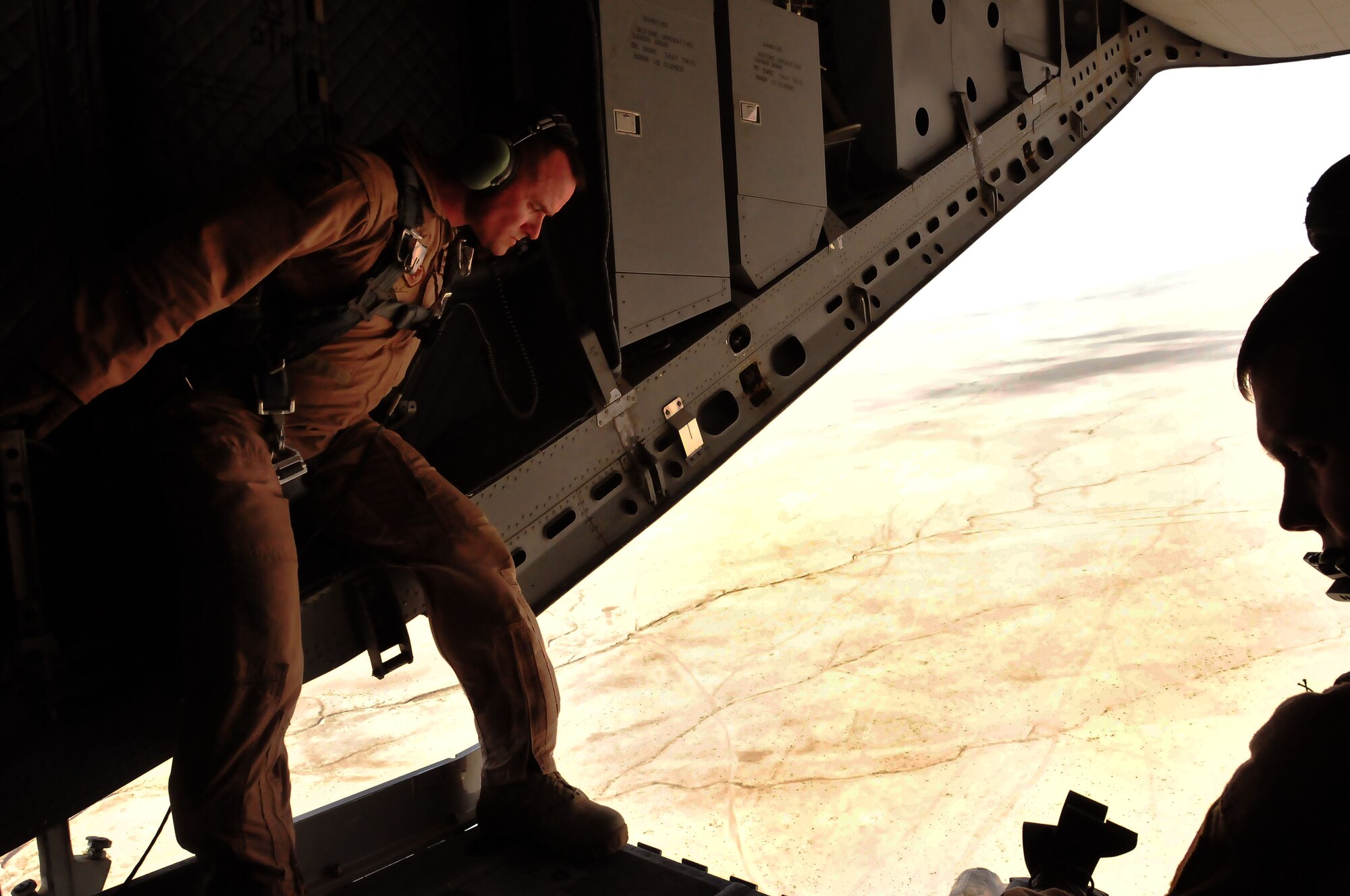 100701-N-6031Q-018 KABUL, Afghanistan -- Load Master, Master Sergeant Chris Ringland, 438th Air Expeditionary Advisory Group stands with Staff Sergeant Talon Martin, 538th Air Expeditionary Advisory Squadron, as they prepare for an air drop on July 1, 2010. This is the first air drop conducted by any crew of the C-27 Spartan transport plane in Afghanistan. (US Navy photo by Mass Communication Specialist 2nd Class David Quillen/ RELEASED).