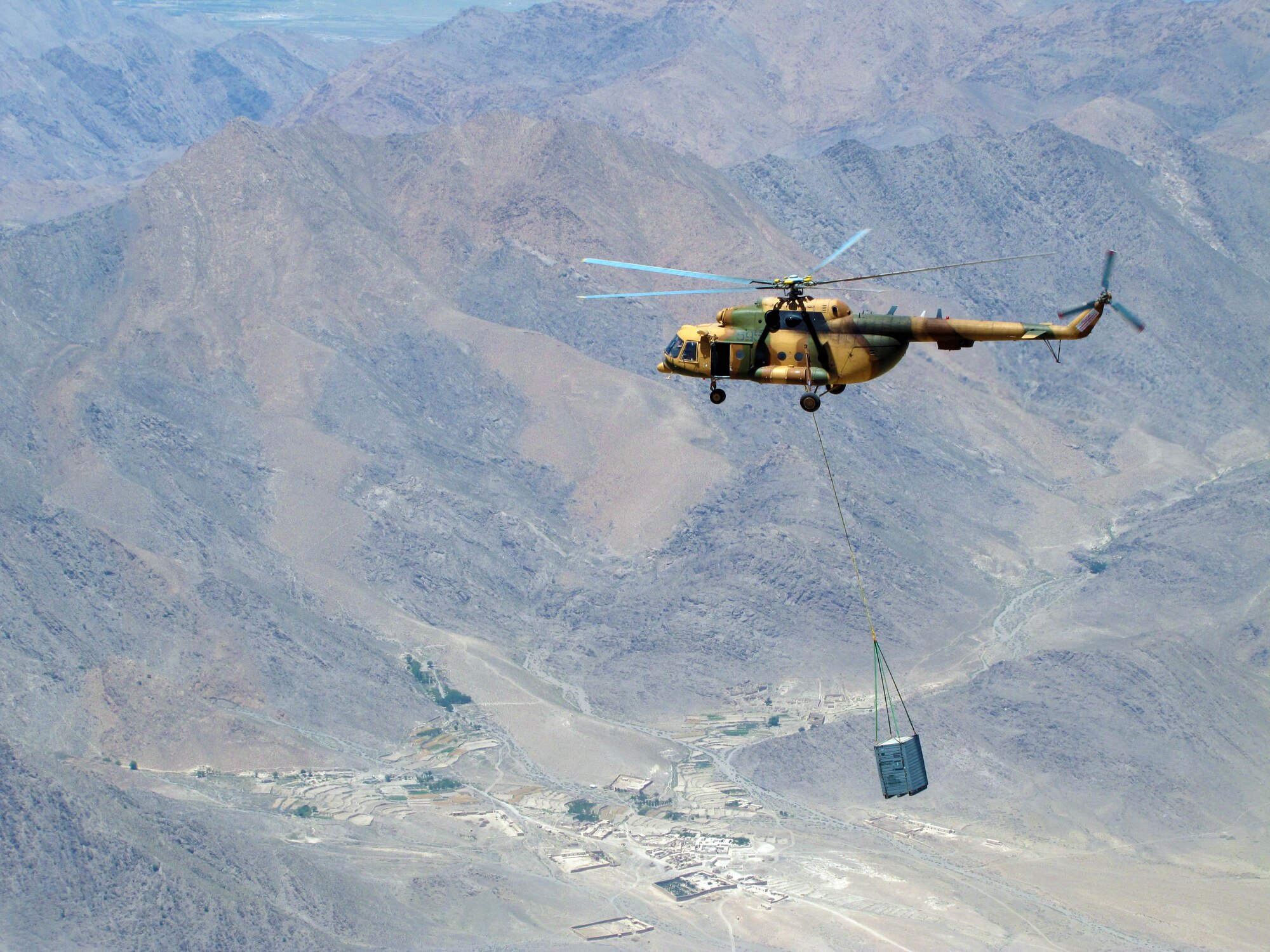 100701-F-5188L-003 KABUL, Afghanistan -- The Afghan Air Force and Combined Air Power Transition Force advisors conducted an operational sling load with the Mi-17 transport helicopter to Orgun-e flying 12,500 feet above sea-level and carrying a 3,200 lbs. crate on July 1, 2010.  . (US Air Force photo by Capt. Robert Leese/ RELEASED).