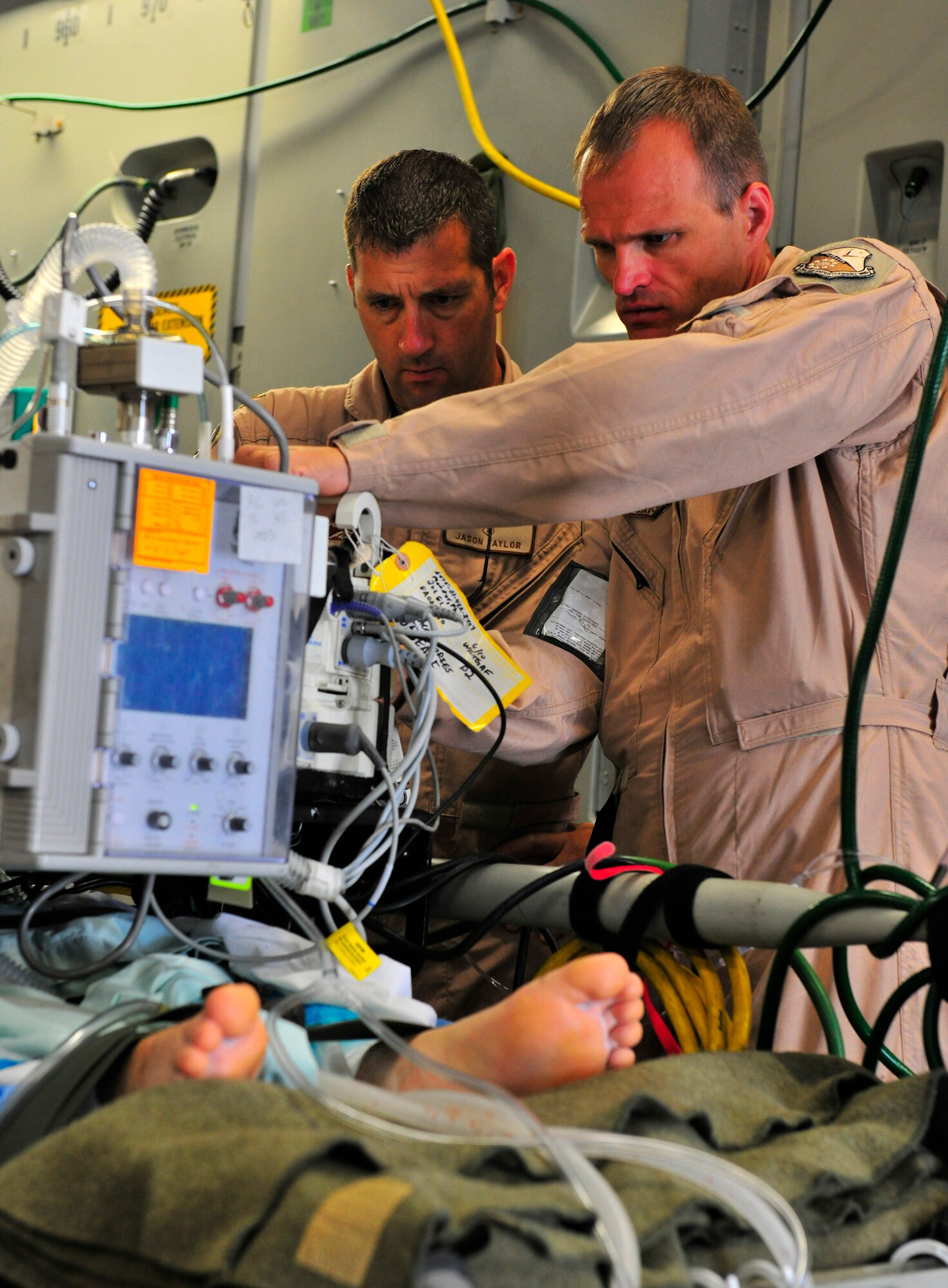 Left to right: Maj. Jason Taylor and Capt. Robert Trobaugh prepare a patient for flight on a C-17 Globemaster III at Bagram Airfield, Afghanistan, July 2, 2010. More than 60 U.S. service members were evacuated to a regional hospital for care in Germany. Major Taylor and Captain Trobaugh are both forward deployed from Al Udied Air Base. (U.S. Air Force photo/Staff Sgt. Christopher Boitz)
