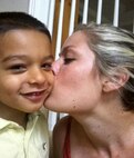 Sgt. Kara Perez kisses her son Roman at their home in Overland Park, Kan. July 4, 2010.