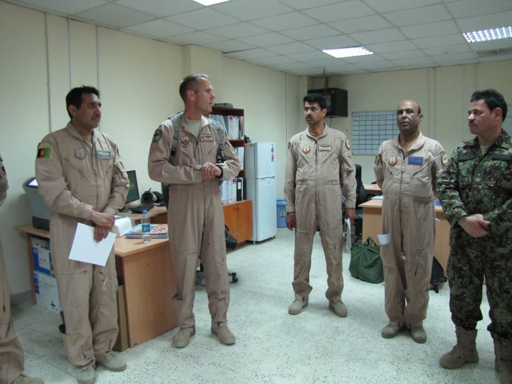 KABUL, Afghanistan - Col. Kenneth Madura, the 438th Air Expeditionary Advisory Group commander presented certificates of C-27 Initial Qualification to Col. Aimal Pacha Saydi, Maj. Qabil Khan and Capt. Nik Mohammad Yosufi in a small ceremony among their peers and the advisors of the Combined Air Power Transition Force on July 3, 2010. (U.S. Air Force photo by Capt. Rob Leese/RELEASED).