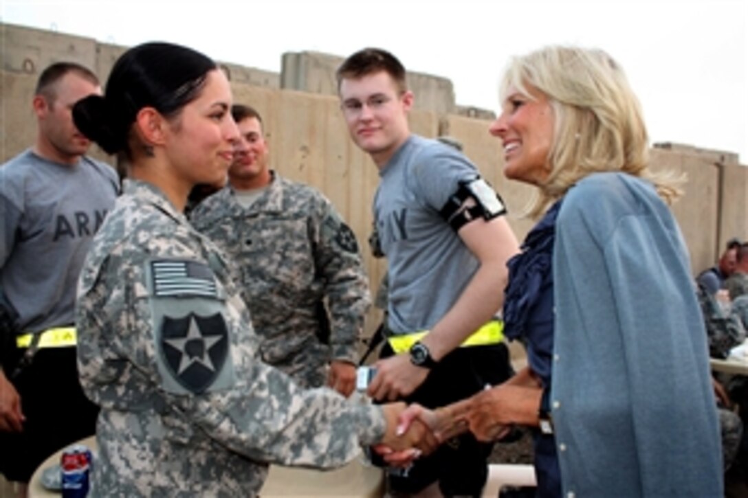Dr. Jill Biden, wife of Vice President Joe Biden, speaks with soldiers of the 2nd Infantry Division's 4th Stryker Brigade Combat Team during an Independence Day barbecue on Camp Victory, Iraq, July 4, 2010. 