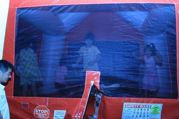 Children bounce away inside a bounce-house before the start of the 2010 Independence Day fireworks display at Penny Lake July 4. Young children were given the opportunity to stay inside any of the four available bounce-houses free of charge.
