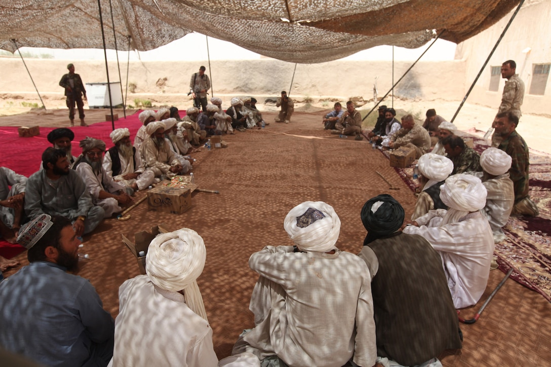 Northern Marjah elders meet during a shura held at Combat Outpost Coutu, Helmand province, Afghanistan, July 5, 2010. Elders met with Marines and Afghan police to discuss recent security issues of concern. The Marines and Afghan National Police pushed forward with the shura, despite a less than expected turnout, to discuss security concerns throughout northern Marjah.