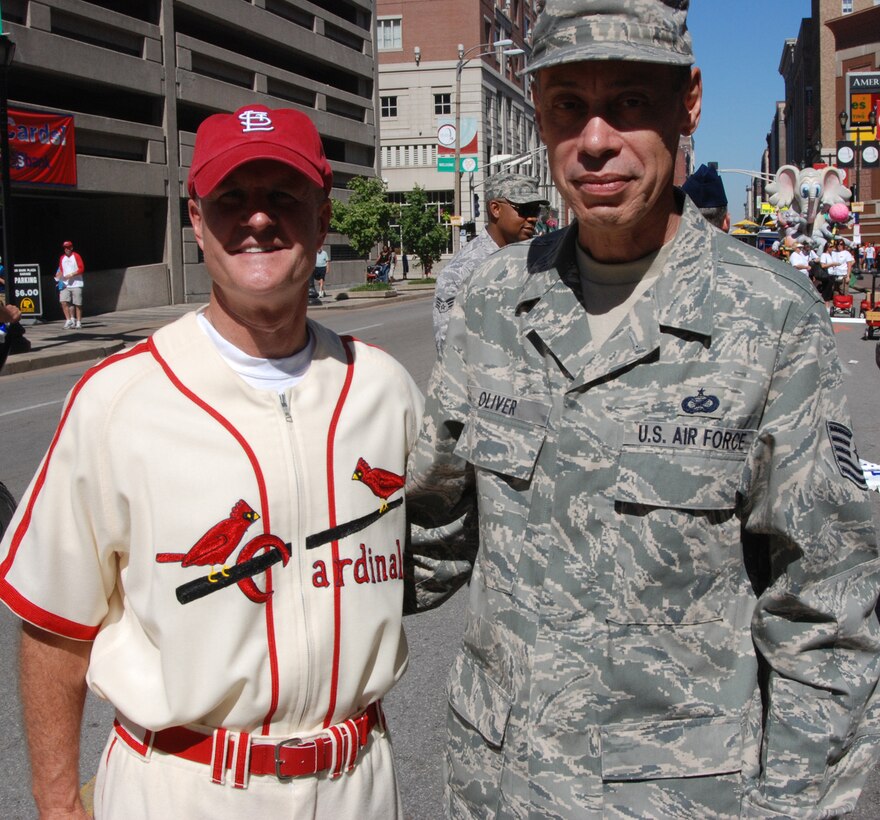 Tech. Sgt. Dan Oliver meets up with a member of the reenactors group portraying Saint Louis Cardinals from 1903 during a community outreach project prior to the Independence Day weekend parade.  "I wish everyone Happy Fourth of July.  I always look forward to participating in this wonderful patriotic event," said Sergeant Oliver as he prepared for the start of the popular Veiled Prophet parade in downtown Saint Louis.  (U.S. Air Force photo/Maj. Stan Paregien)