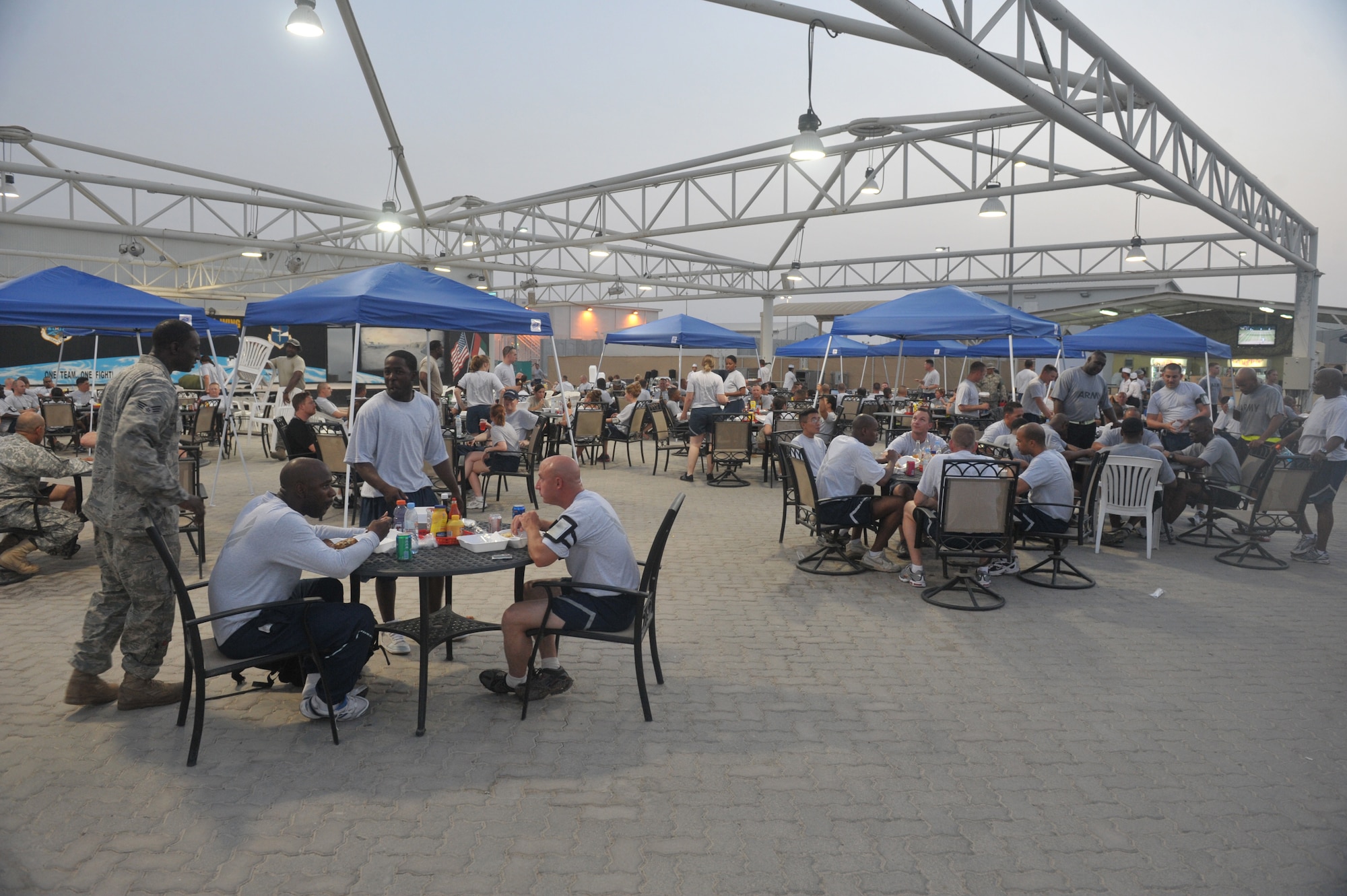 Airmen of the 380th Air Expeditionary Wing and Soldiers enjoy a barbecue July 4 at an undisclosed location in Southwest Asia. The meal was one of multiple events during the celebration of Independence Day here. (U.S. Air Force Photo/ Senior Airman Brad Kasch)