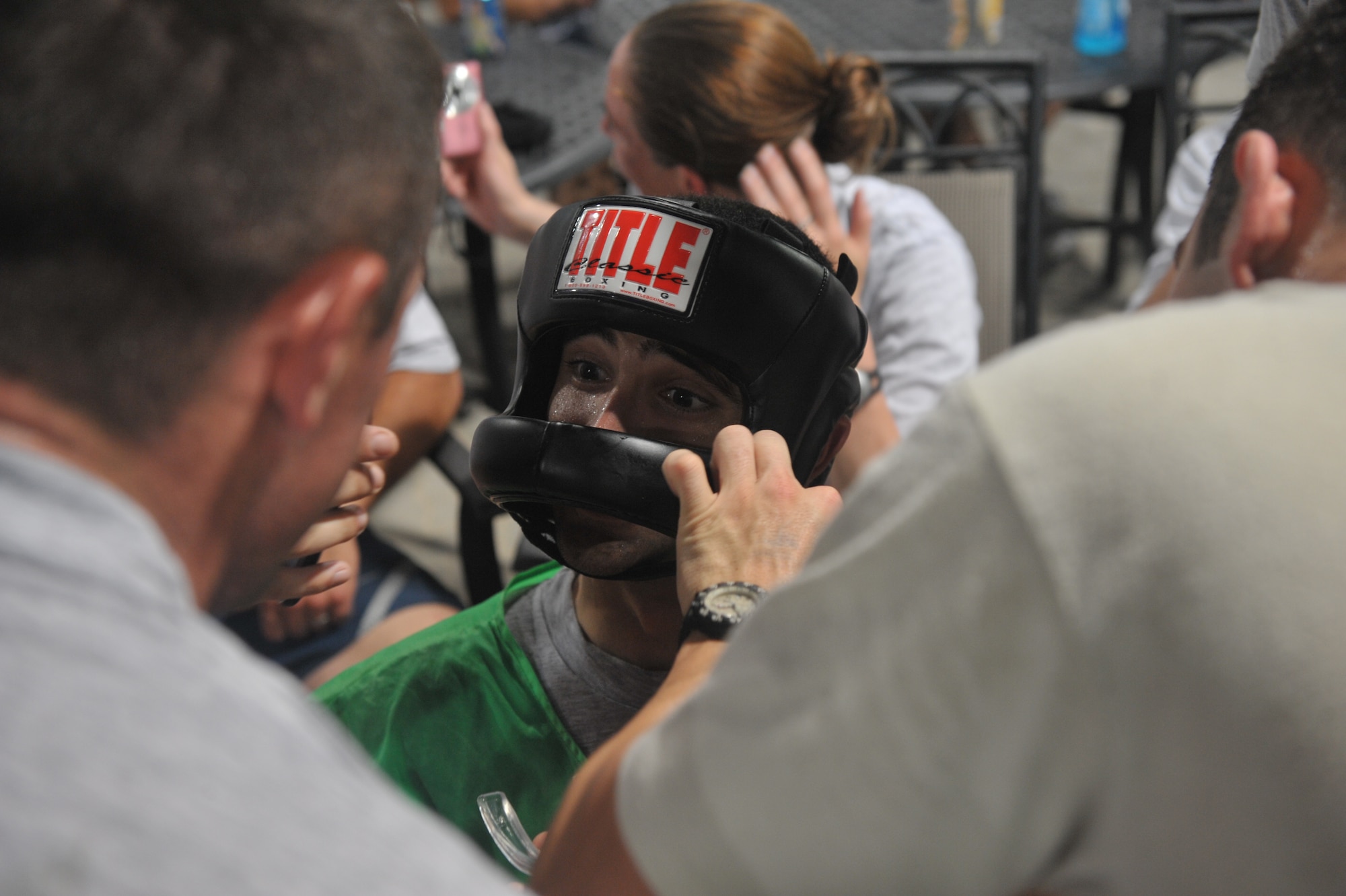 A participant in the fight night event sits in his corner between rounds July 4 at an undisclosed location in Southwest Asia. The event capped off a full day of events celebrating Independence Day here. (U.S. Air Force photo/Staff Sgt Jeremy Larlee)