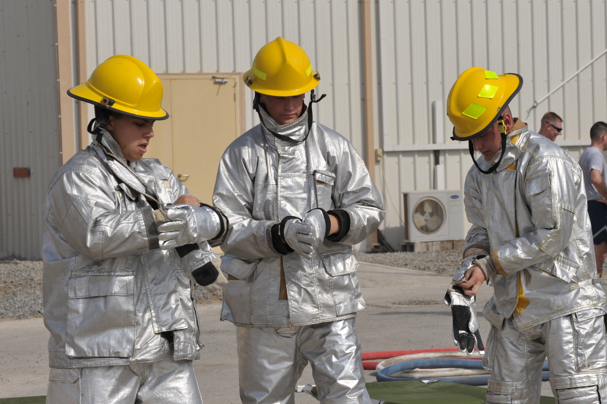 Air Force participants gear up during the fire muster challenge July 4 at an undisclosed location in Southwest Asia. Air Force cadets, Airmen, and Soldiers participated in the event with Cadet team 2 winning. (U.S. Air Force photo/Tech. Sgt April Wickes) 