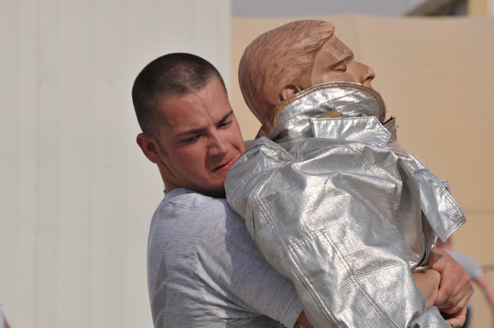 2nd Lt. Josh Haskins, Expeditionary Civil Engineer Squadron team one, drags a training dummy a fire muster challenge July 4 at an undisclosed location in Southwest Asia.  Air Force cadets, Airmen, and Soldiers participated in the event with Cadet team 2 winning. (U.S. Air Force photo/Tech. Sgt April Wickes)