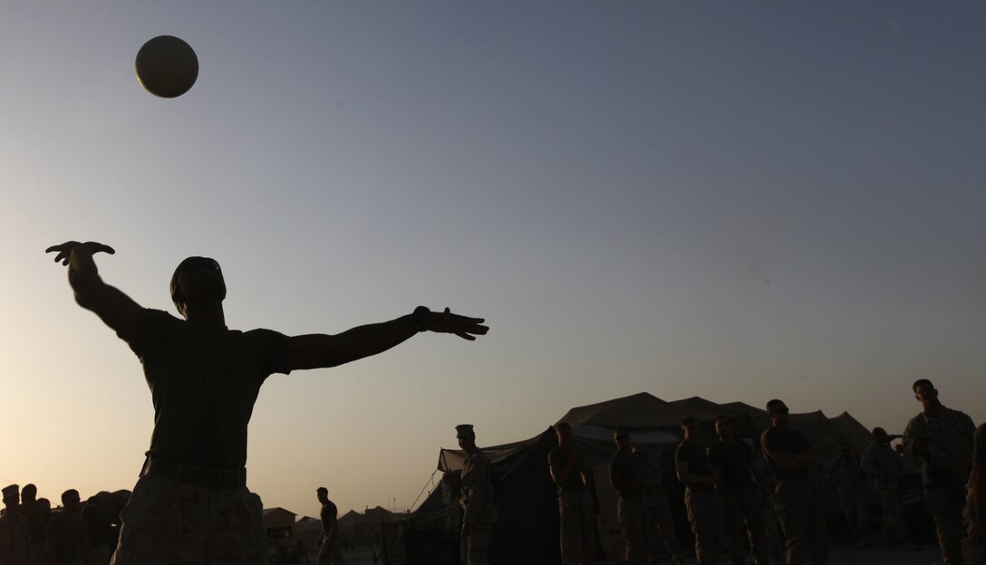 A Marine from Combat Logistics Battalion 6, 1st Marine Logistics Group (Forward) serves the ball during a volleyball game as part of a post-Independence Day field meet at Camp Leatherneck, Afghanistan, July 5. Marines and sailors formed teams to compete in various challenges including volleyball, weightlifting, pull-ups and tug-of-war.