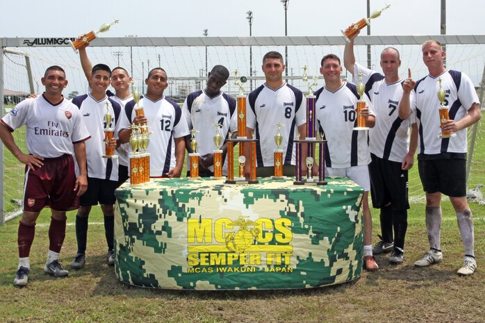 MWSS-171 poses with their trophies after taking first place in the six-on-six soccer tournament at Penny Lake here July 5.  MWSS-171 beat the Legends 4-1 during the final game. Even though MWSS-171 took home first place, the Legends were happy to accept the second place trophy.