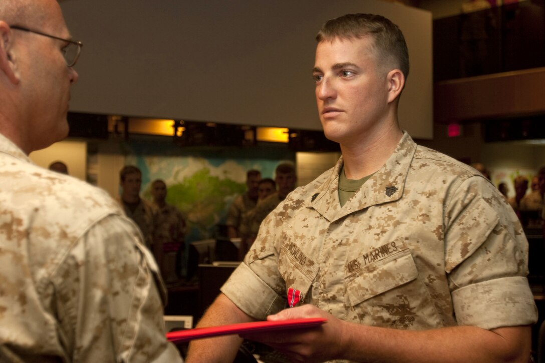 Col. John Lowrey, U.S. Marine Corps Forces, Pacific’s Regional Operations and Plans officer in charge, presents Sgt. Michael G. Dowling a Bronze Star with “V” device for valor July 6 at the MarForPac Headquarters, Camp H. M. Smith, Hawaii. Dowling, a scout sniper currently serving as the ROPS noncommissioned officer in charge, led more than 30 missions as a scout sniper team leader during his 2009 Afghanistan deployment with 2nd Battalion, 3rd Marine Regiment.