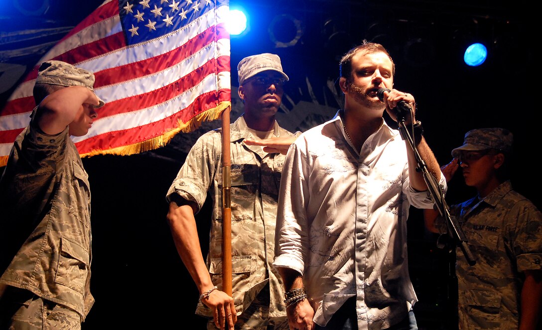 Wade Bowen, a Texas-born country singer, performs "Star-Spangled Banner" to a crowd of about 35,000 people during Freedom Fest 2010 July 3, 2010, at the Sheppard Clinic pavilion at Sheppard Air Force Base, Texas.  Freedom Fest 2010 featured a volleyball tournament, car show, a variety of foods, performances by various musical bands and a fireworks presentation. (U.S. Air Force Photo/Mike Litteken)
