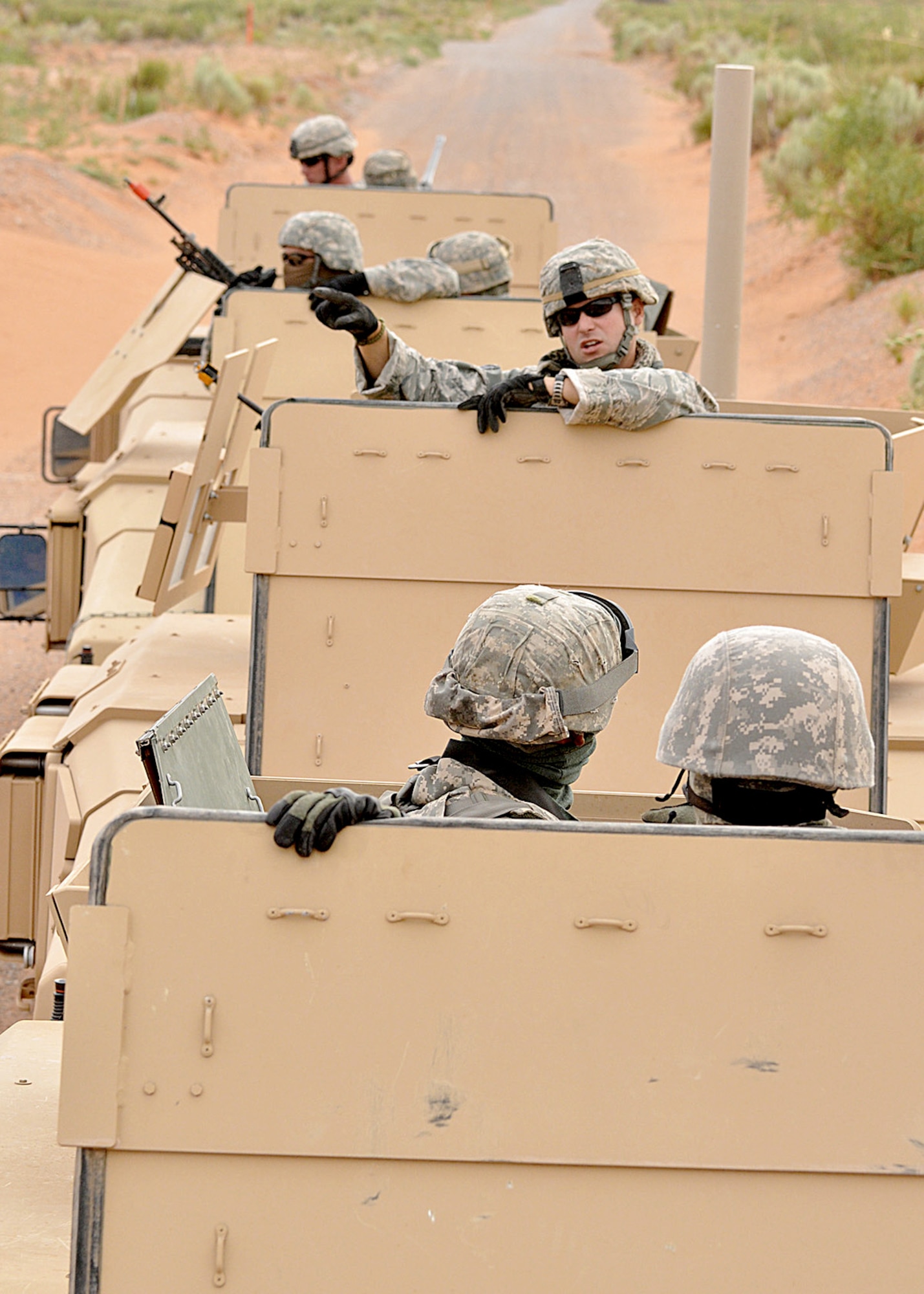 Staff Sgt. Ryan Deane talks with security forces Airmen during a convoy live fire exercise June 30, 2010, on a range in New Mexico. Sergeant Deane is assigned as an instructor at the Desert Defender Regional Training Center, which is operated by the Texas Air National Guard's 204th Security Forces Squadron. (U.S. Air Force photo/Master Sgt. Mike R. Smith)