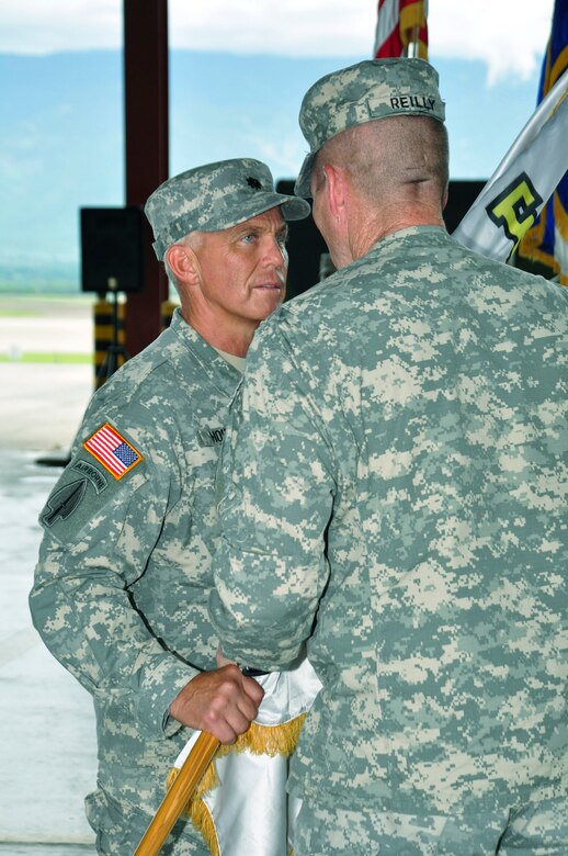 SOTO CANO AIR BASE, Honduras --  Lt. Col. Michael Hoilien takes a guidon from Col. Gregory Reilly, the Joint Task Force-Bravo commander, during the Medical Element change of command ceremony here June 17. Colonel Hoilien took command of MEDEL from Col. Marie Dominguez. (U.S. Air Force photo/Martin Chahin)