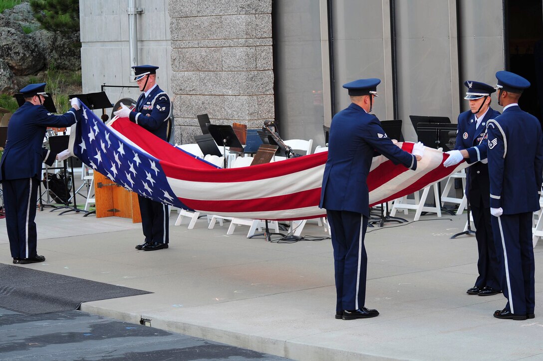 ELLSWORTH AIR FORCE BASE, S.D. – Members of the Ellsworth Honor Guard perform a flag folding ceremony in recognition of Ola Mildred Rexroat during the 2010 Independence Day celebration at Mt. Rushmore National Memorial, July 3. Mrs. Rexroat received the Congressional Gold Medal on March 10 for her military service. (U.S. Air Force Photo/Airman 1st Class Corey Hook)